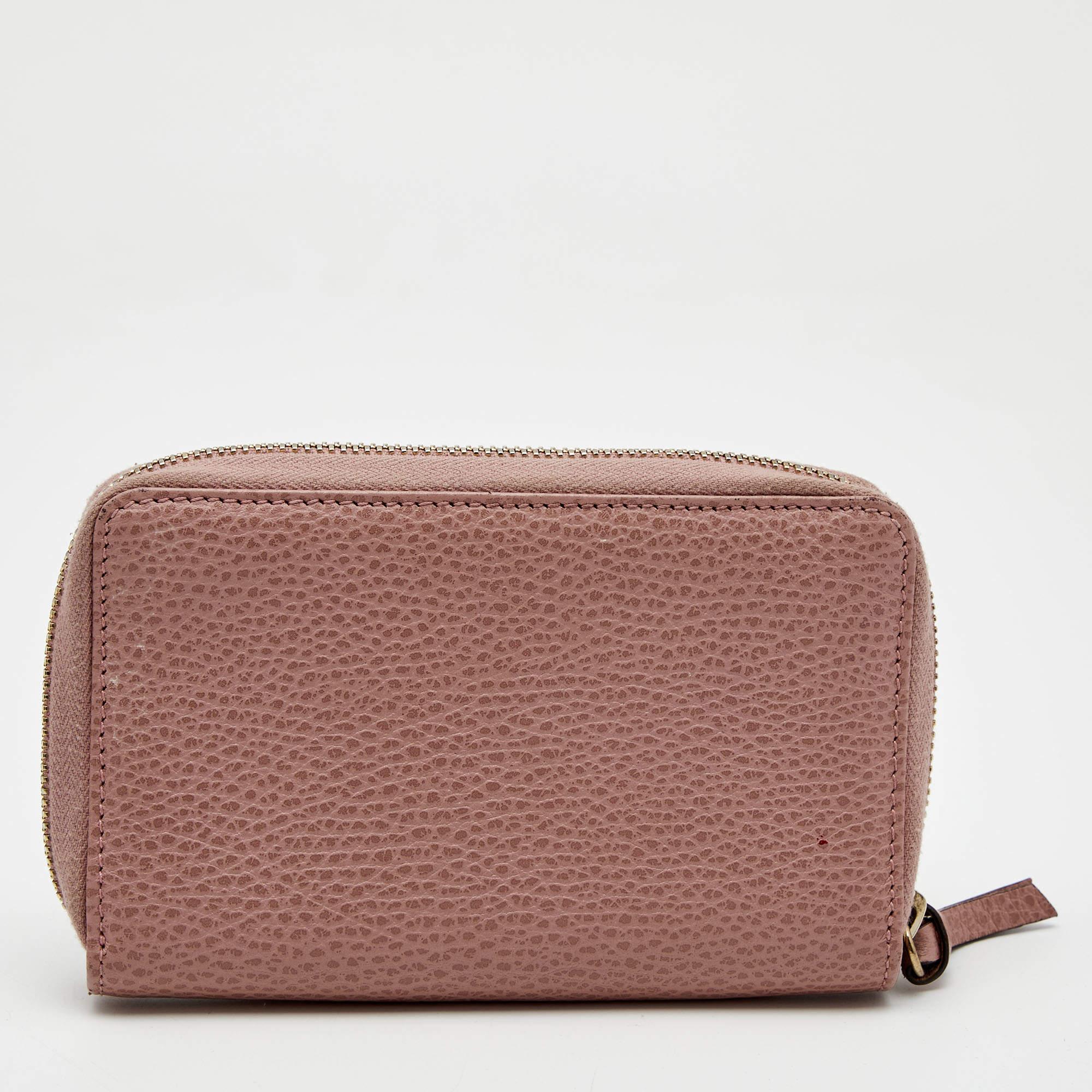 Make this functional wallet from Gucci your go-to accessory this season. Created with pink leather on the exterior, this wallet will lend a luxe appearance to your ensemble. The zip-around closure opens to a well-sized interior that accommodates all