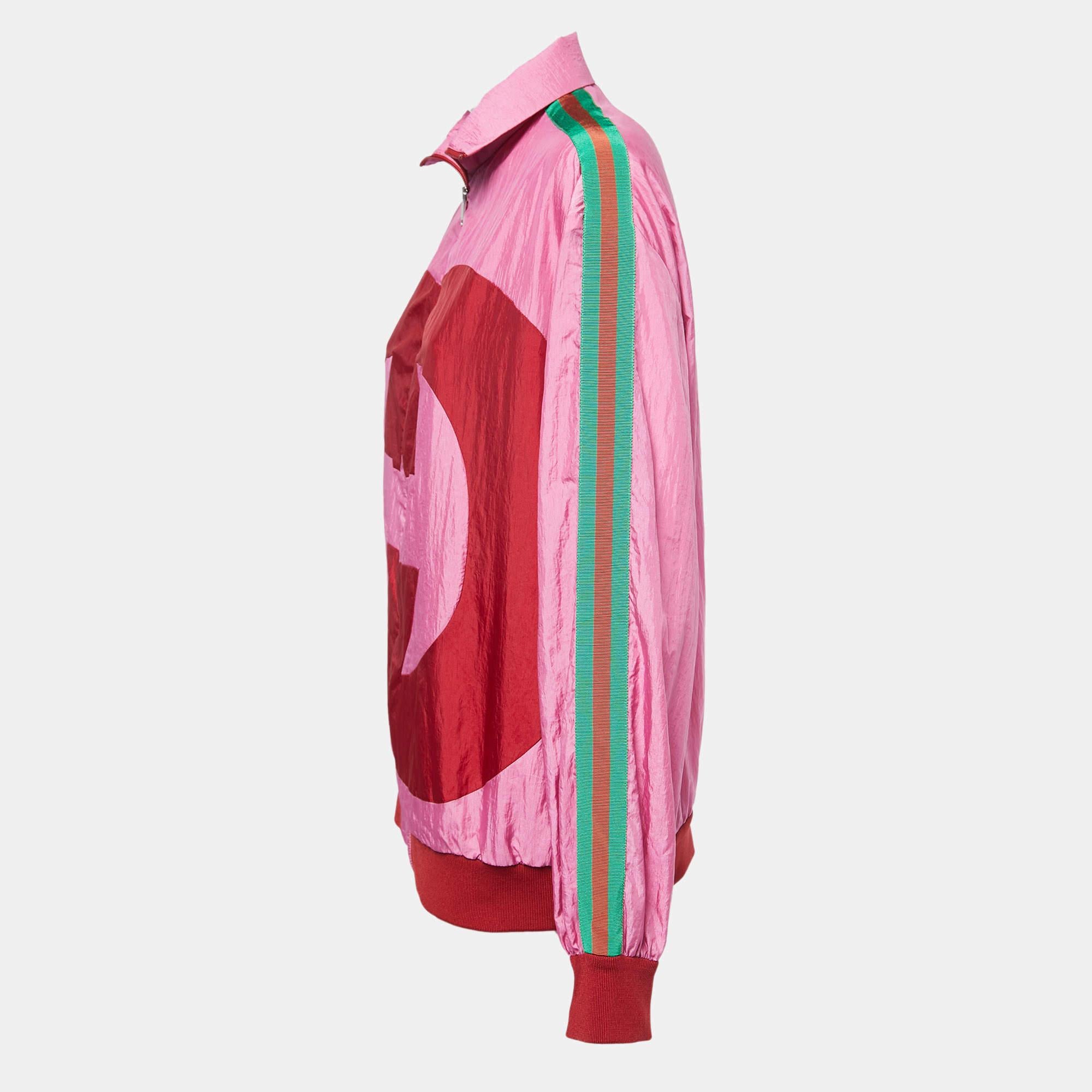 The Gucci bomber jacket is a vibrant and stylish outerwear piece that combines luxury and streetwear. Featuring a striking colorblock design in pink hues and bold web stripes, this jacket showcases the iconic Gucci logo for a statement-making look.