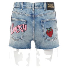 GUCCI pink logo graffiti red strawberry patch blue denim cut off shorts 22"