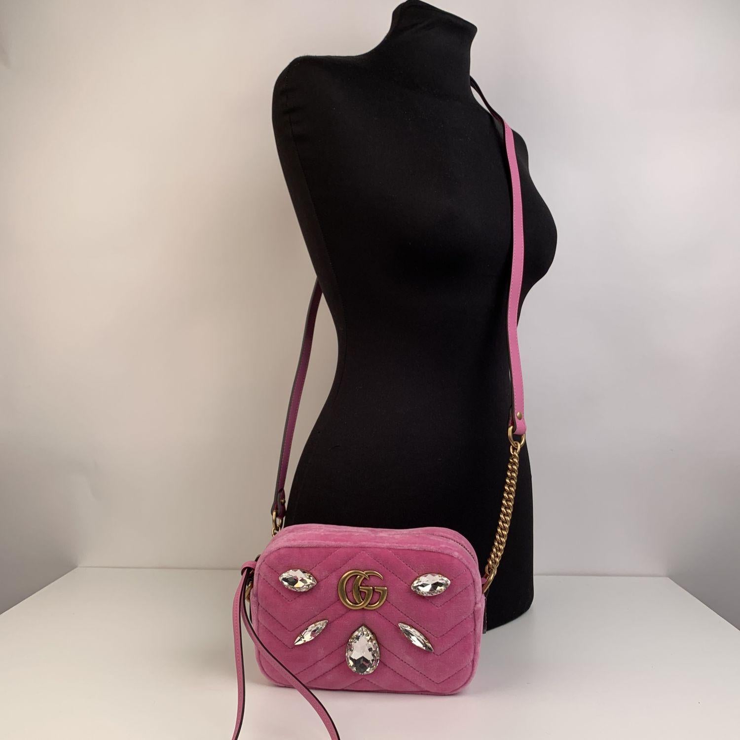 Lovely Gucci 'Mini GG Marmont' camera bag in pink matelassé velvet. The bag features a chevron quilted motif, double GG logo in antiquated gold tone was inspired by the Running G motif, from the Gucci archieves of the 1970s and 5 beautiful bold