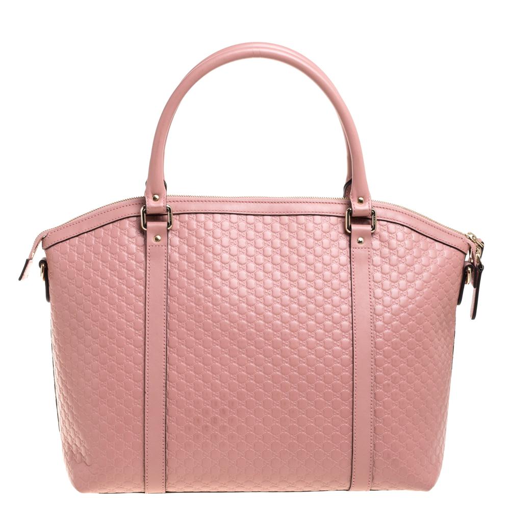 Acquire a stylish look carrying this Dome satchel from the house of Gucci. Its pink color leaves a powerful impact on the onlookers, and microguccissima leather reflects elegance. The versatility lies in the dual-rolled handles and long shoulder
