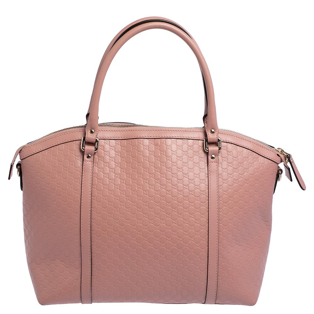 Exquisitely crafted in Italy from microguccissima leather, this Gucci satchel exudes a luxe appeal. The bag suspends from dual handles, and the spacious canvas-lined interior is secured with double zip fastening. The bag is ideal for daily