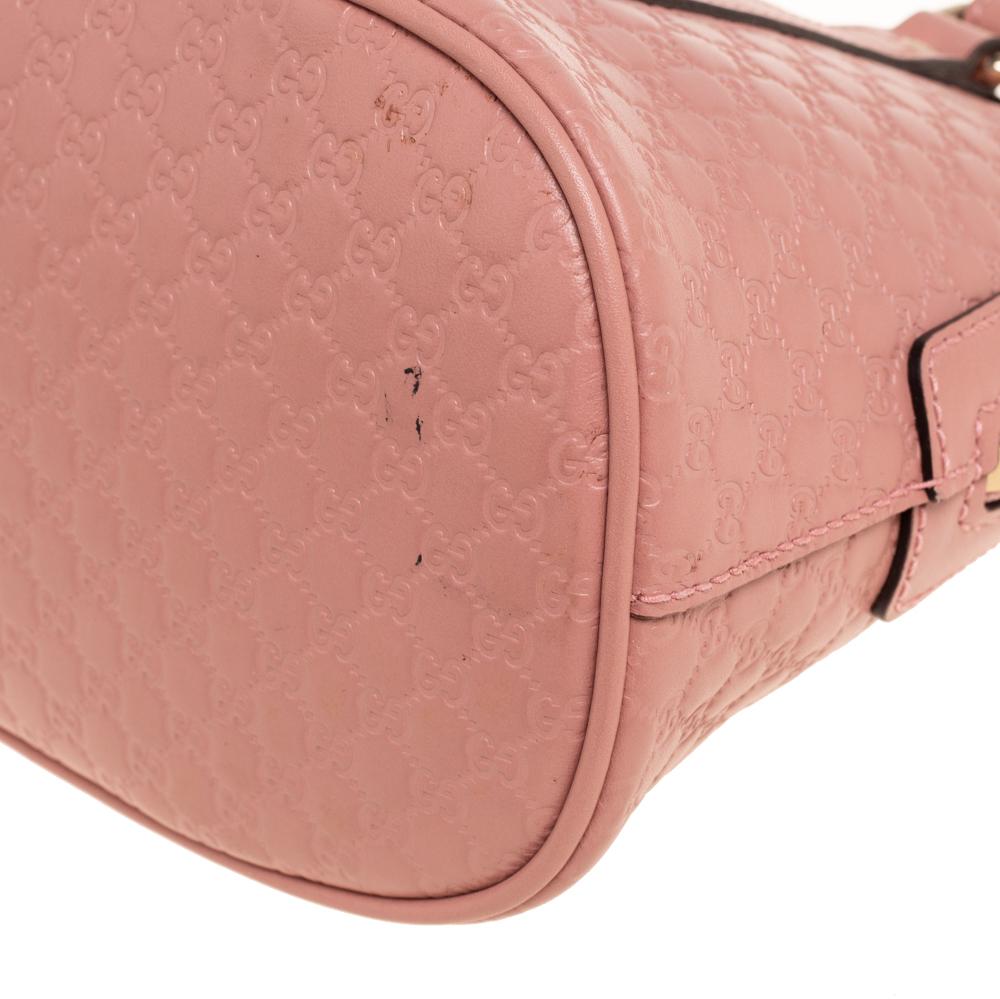 Hold everything you need in style with this Mini Dome bag from the house of Gucci. Its pink color exudes a sweet appeal, and the Microguccissima leather projects the iconic Gucci charm. The versatility lies in the dual-rolled handles and long