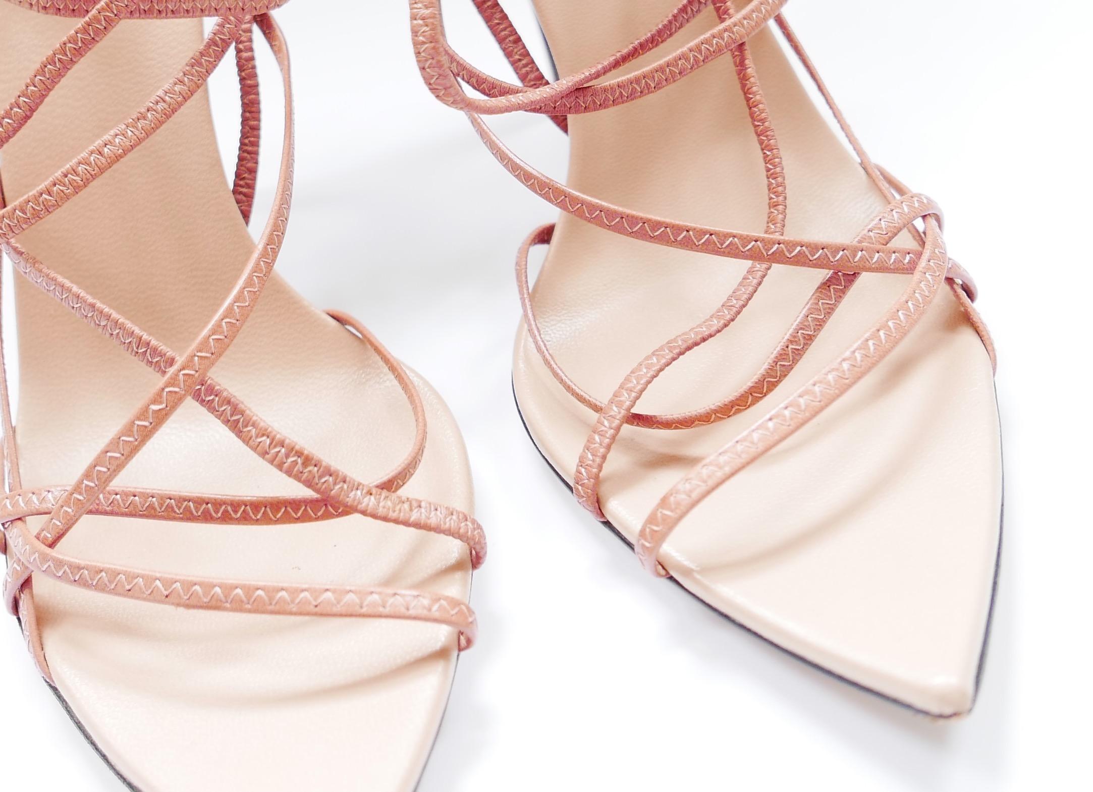 Gorgeous Gucci archival pointed sole strappy sandals in rose pink leather with multiple delicate, stretchy straps and stiletto heels. size 39C/UK6. Measures approx - 10.5” heel to toe and heel is 4.5”. Show lightest wear
