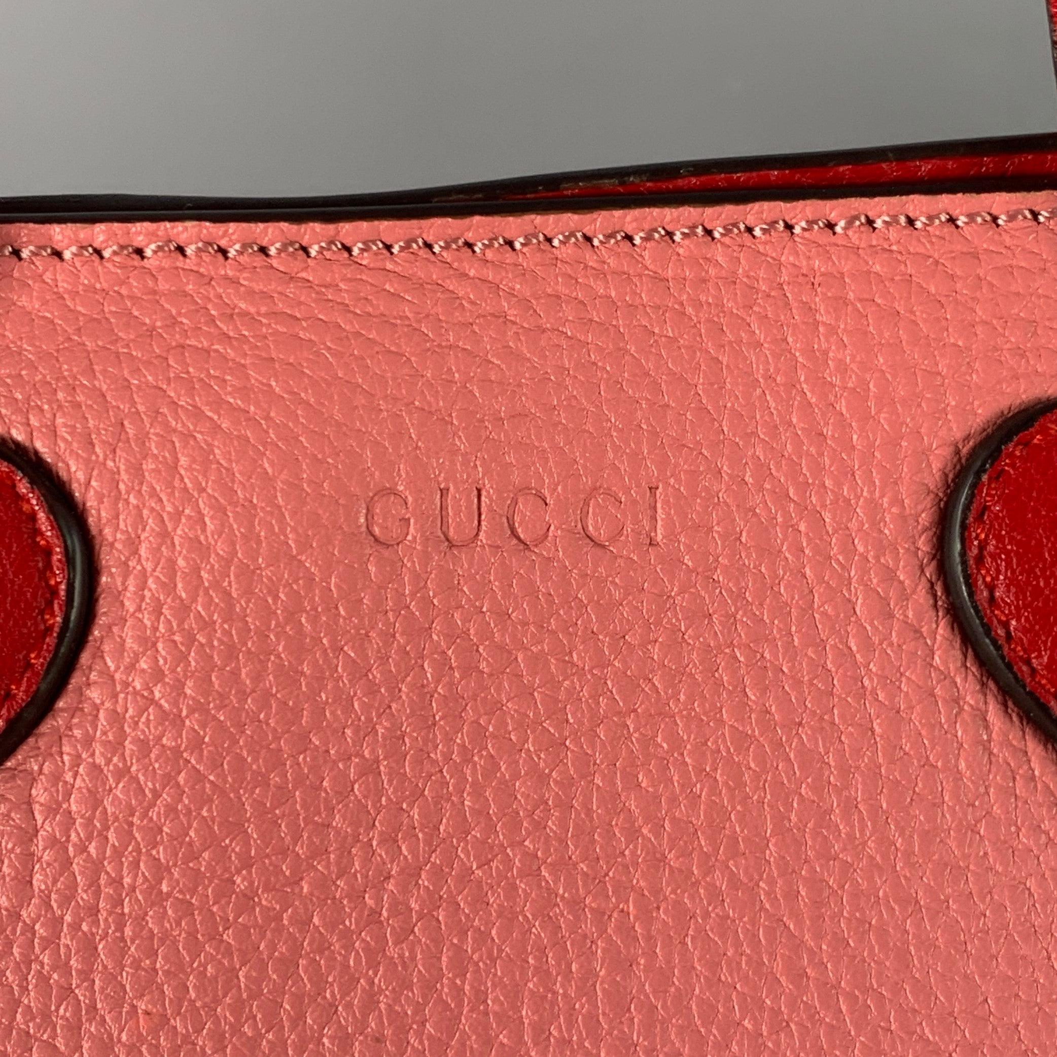 GUCCI KIDS tote
in a pink pebble grain leather featuring red leather top handles with heart details, giraffe lining, and single magnet closure. Made in Italy.Very Good Pre-Owned Condition. 

Marked:   457195 891012 

Measurements: 
  Length: 8.25