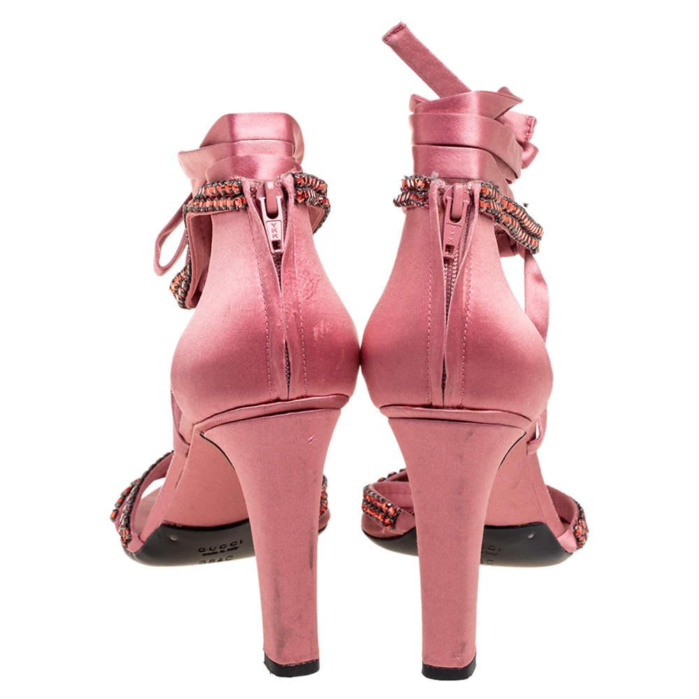 Gucci's timeless aesthetic and stellar craftsmanship in shoemaking is evident in these stunning sandals. Crafted from satin, they are designed with slender straps, open-toes, crystal embellishments, and high heels.

