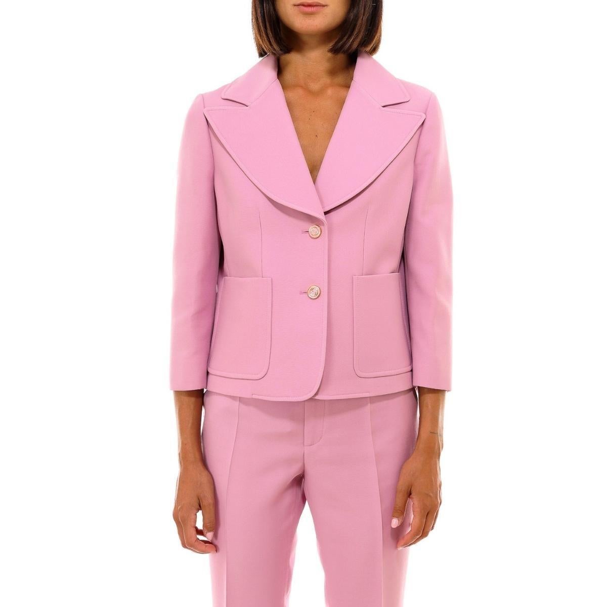 Long sleeve wool cady crepe blazer in pink. 
Peaked lapel collar. 
Two-button closure at front. 
Patch pockets at waist. 
Darts at front and shoulders. 
Princess seams at front and back. 
Textile lining in gold-tone. 
Fully lined. 
Tonal and