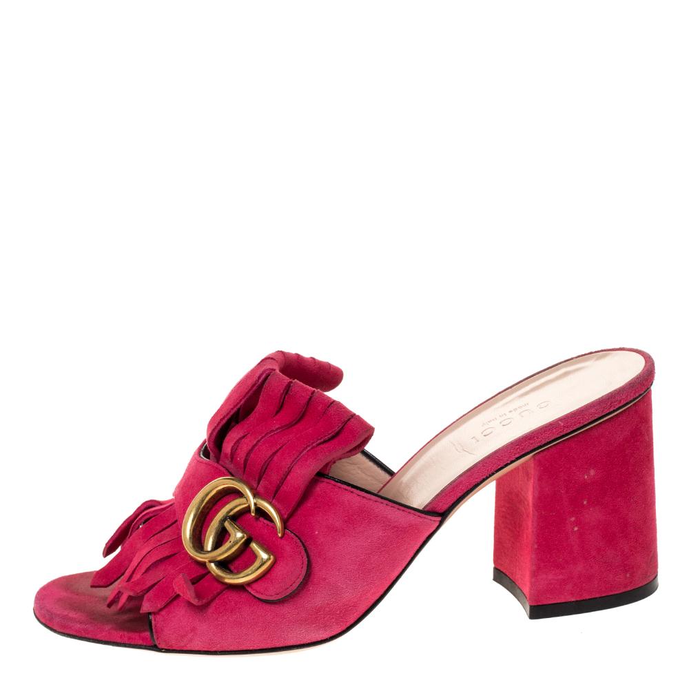 One of the iconic and instantly recognizable designs from the house of Gucci, these GG Marmont mules are here to stay. Crafted in soft pink suede, these mules feature covered block heels for comfort along with folded fringed details over the vamps