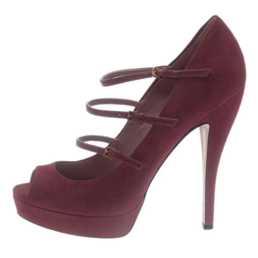 Add the prefect pop of color to your oufit with these Gucci Platform Pumps. Made from pink colored suede, they are coupled with rounded peep toes, three buckle adjustable straps across their vamps, 2cm platforms and 14cm heels. Leather lined, their