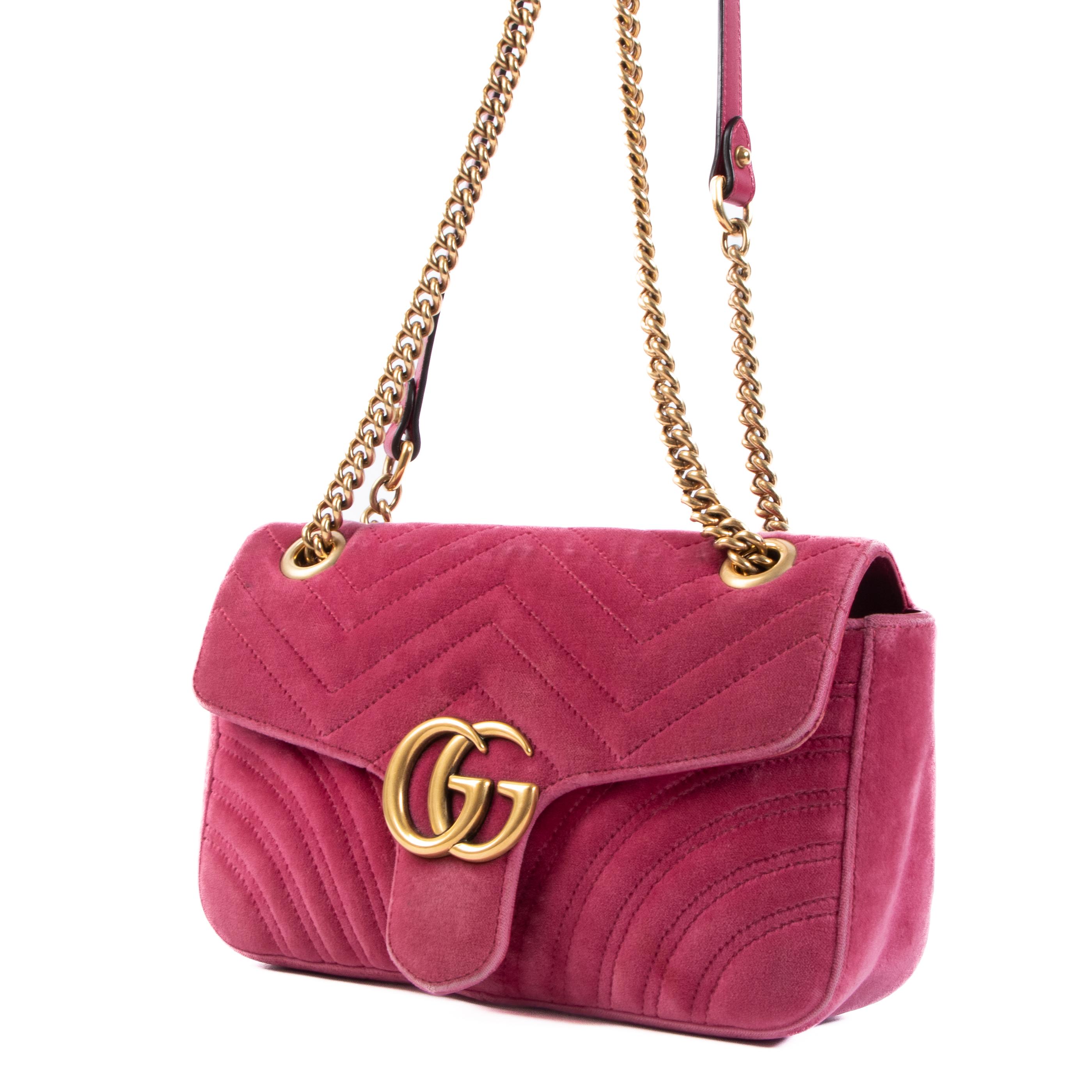 The Gucci Pink Velvet GG Small Marmont Crossbody bag is a stylish and elegant designer handbag that is crafted from luxurious pink velvet material. It is a part of Gucci's Marmont collection, which is known for its iconic double GG logo design.

The