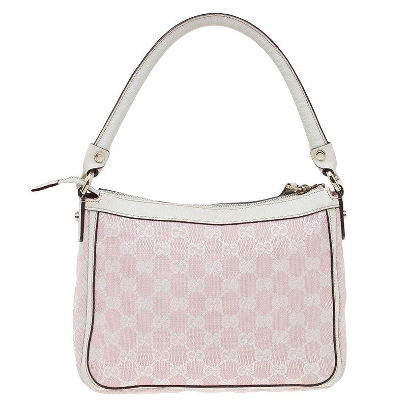 Stay chic with this bag by Gucci. Crafted from Gucci’s classic monogram canvas with leather trim, the exterior features a single rolled handle and gold-tone hardware. Its large interior is lined with fabric and features a patch pocket and a zip