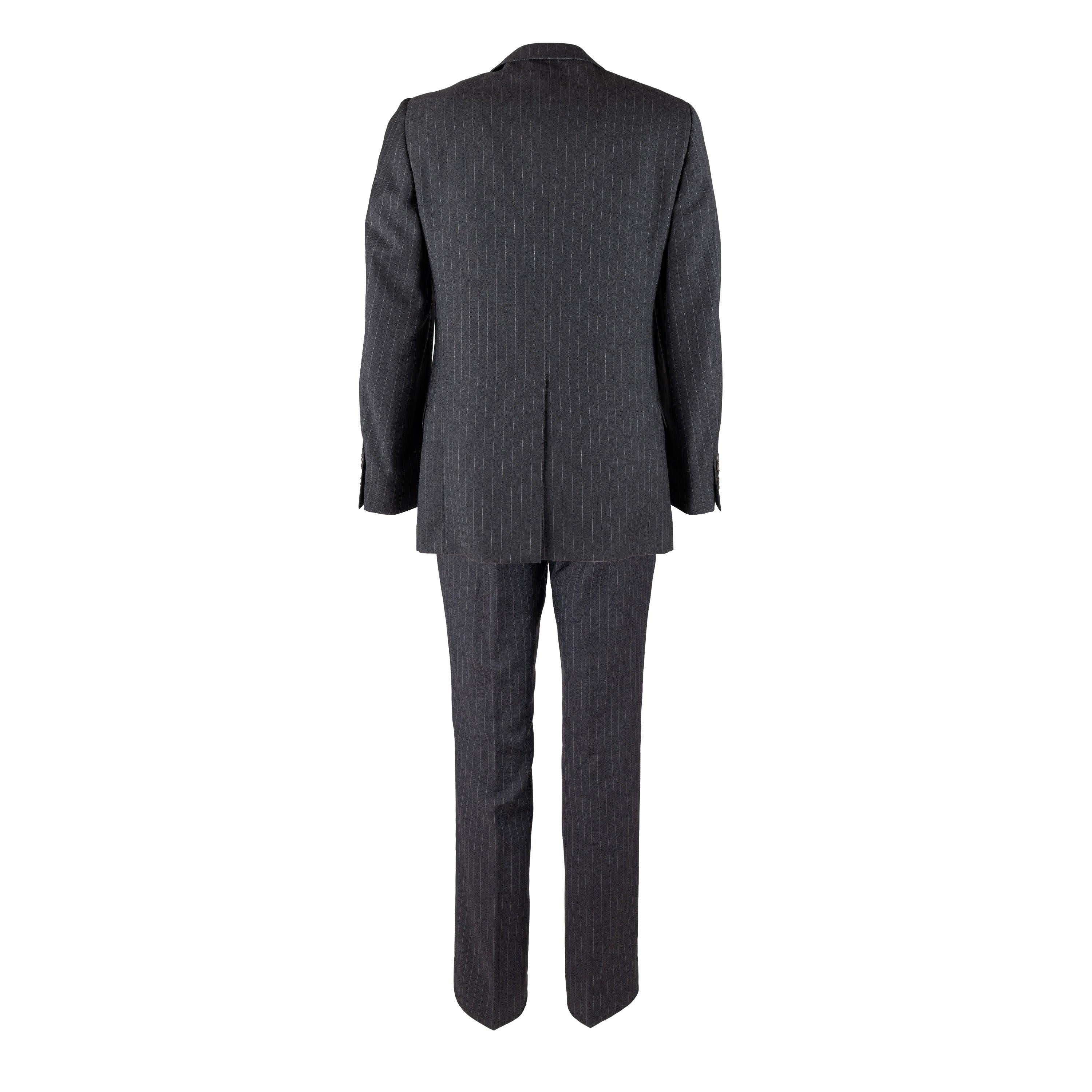 Stay sharp and professional with this Gucci Pinstripe Suit from the 2000s. Meticulously tailored with 100% pure wool, this suit features a lapel collar with 3 buttons and flap pockets for a classic look. The pant has a straight fit and the dark grey