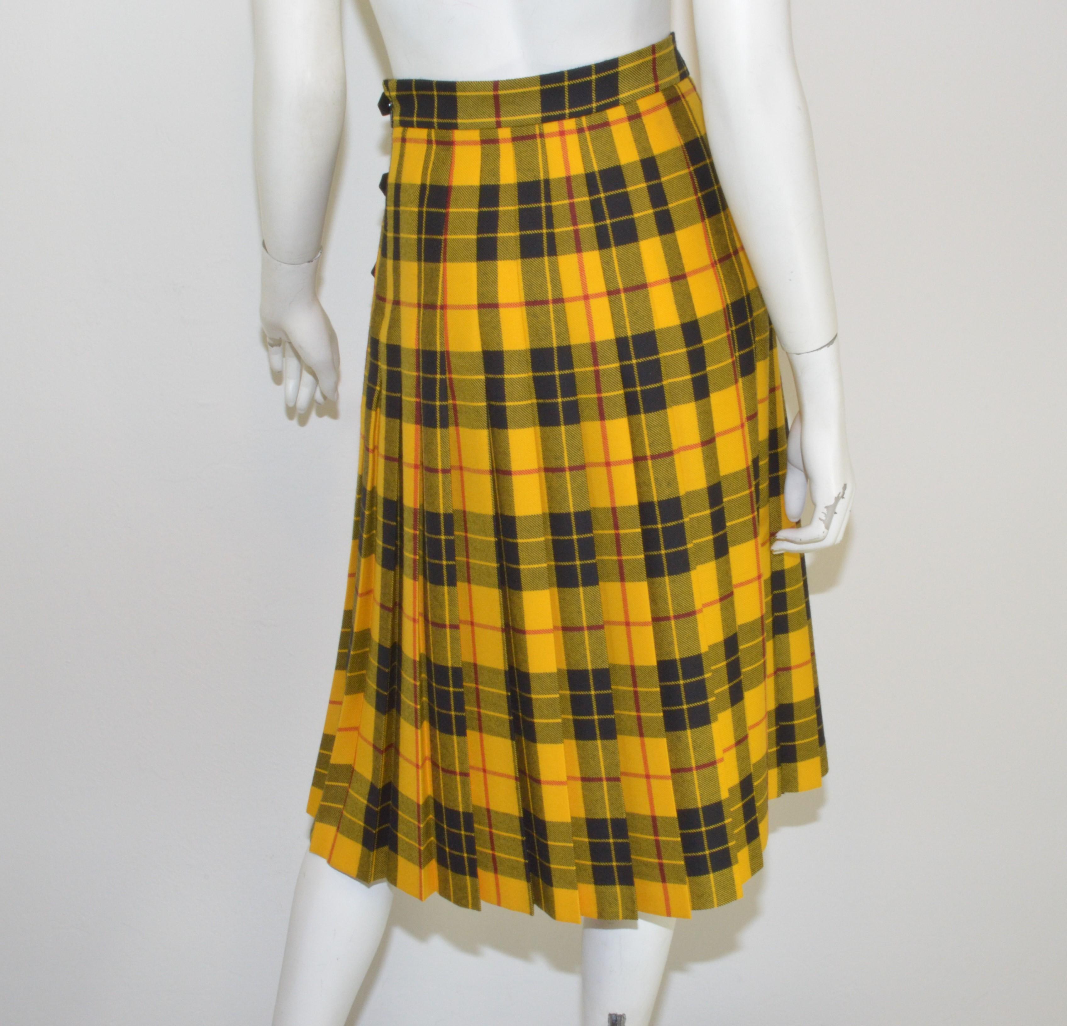 Gucci Plaid Kilt Skirt with Embroidered Dog Motif - Skirt is featured in a yellow, black and red color combination with a pleated design, adjustable leather buckles along the left hip, back side zipper fastening, 100% wool. Skirt is labeled a size