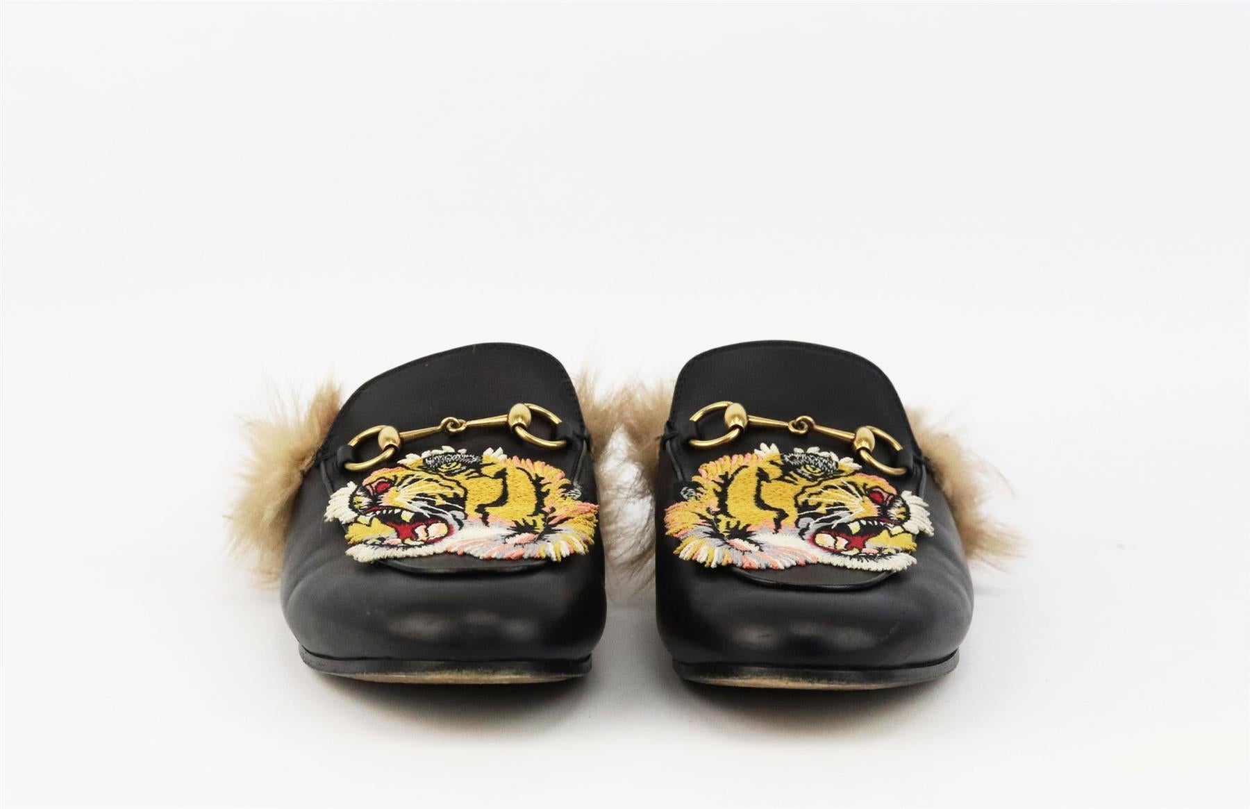 These ‘Princetown’ slippers by Gucci have been made in Italy from smooth black leather, lined in shearling-fur and topped with embroidered tiger appliqués. Sole measures approximately 10 mm/ 0.5 inches. Black leather. Slip on. Does not come with box