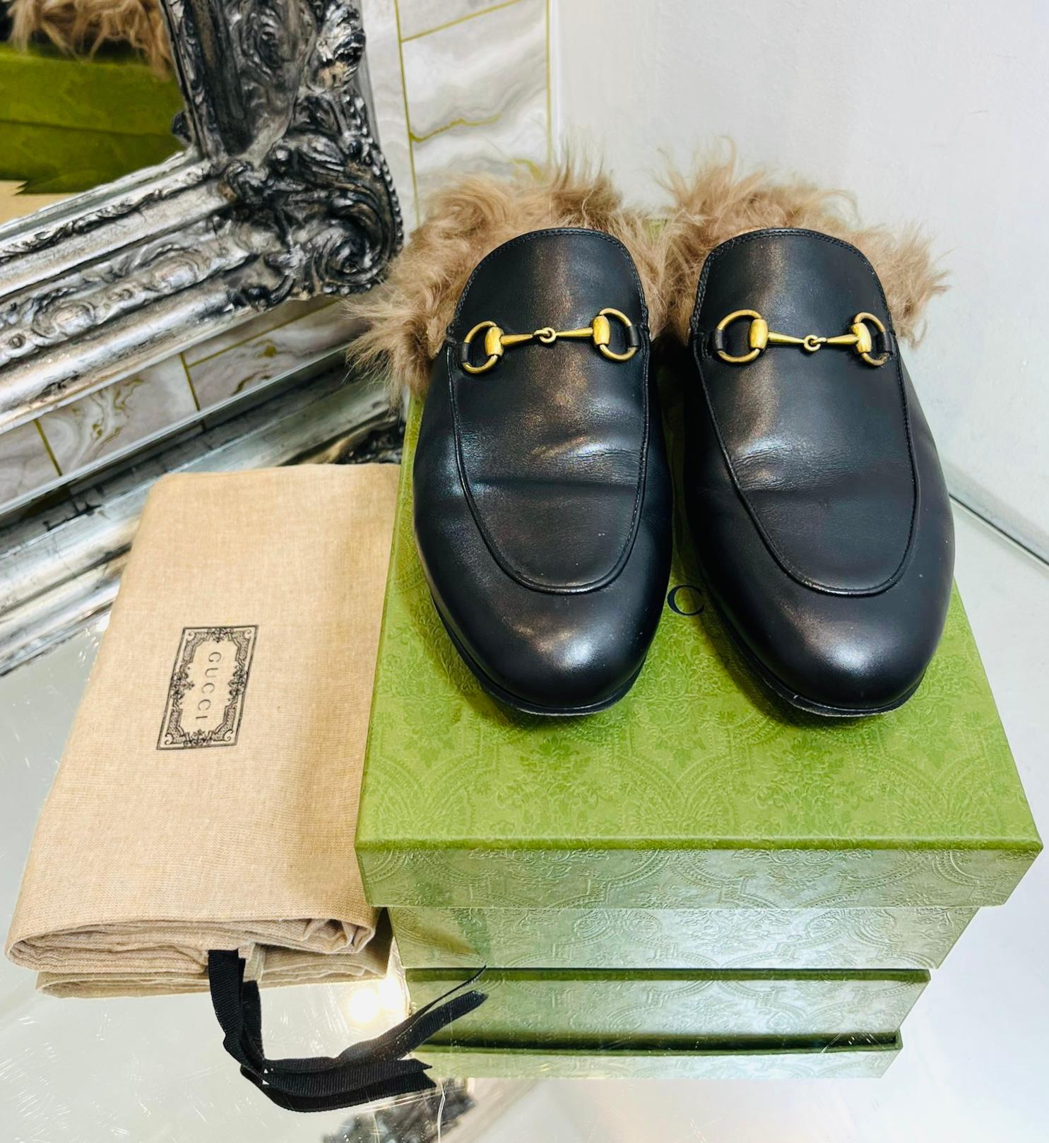 Gucci Princetown Leather Shearling-Lined Mules

Black slip-on mules designed with the brand's signature gold Horsebit embellishment to the front.

Detailed with shearling lining, almond toes and flat leather soles.

Size – 40

Condition – Very Good