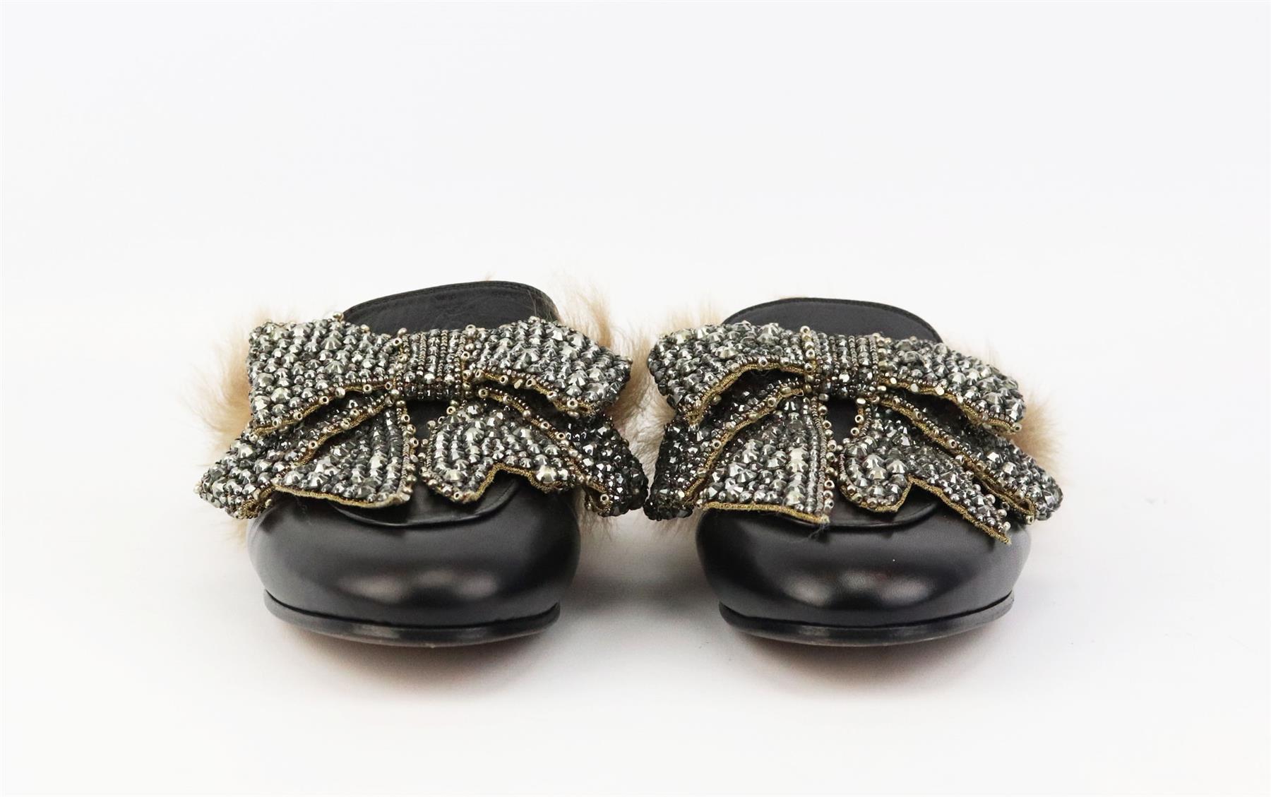 These ‘Princetown’ slippers by Gucci have been made in Italy from smooth black leather, lined in shearling-fur and topped with a crystal-embellished bow. Sole measures approximately 10 mm/ 0.5 inches. Black leather, brown shearling. Slip on. Does