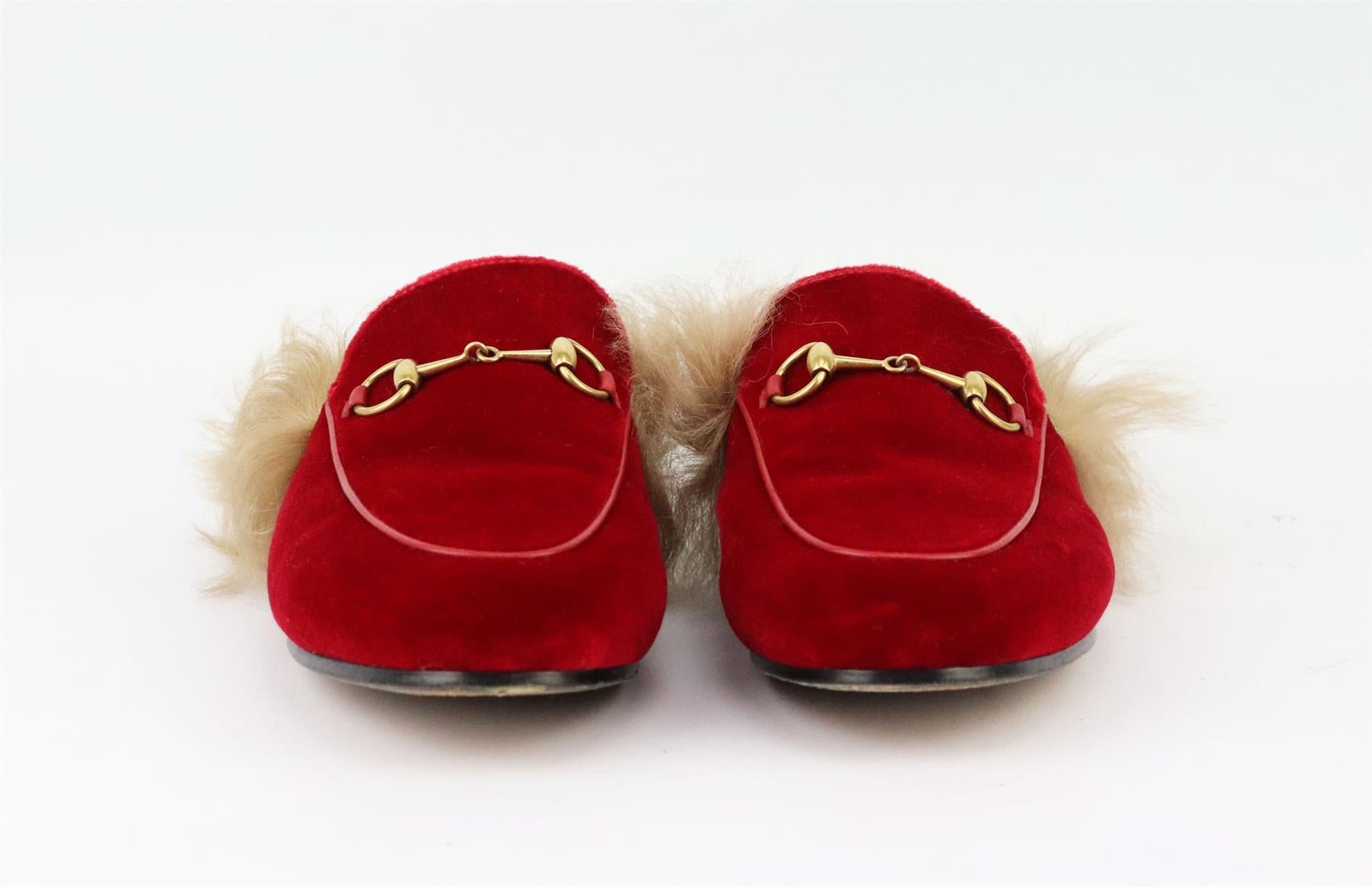 The ‘Princetown’ slippers by Gucci have been made in Italy from vibrant red velvet, lined in brown shearling and finished with the brand's signature horsebit hardware on top. Sole measures approximately 10 mm/ 0.5 inches. Red velvet, brown