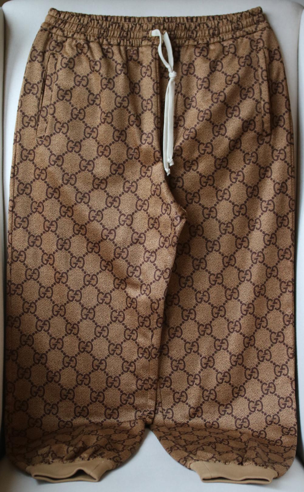 Tap Gucci’s elevated approach to sportswear codes with these brown GG trackpants. Crafted from cotton-blend jersey, this Italian-crafted style offers a relaxed silhouette with a drawstring waist and elasticated cuffs. Side slit pockets. Designer