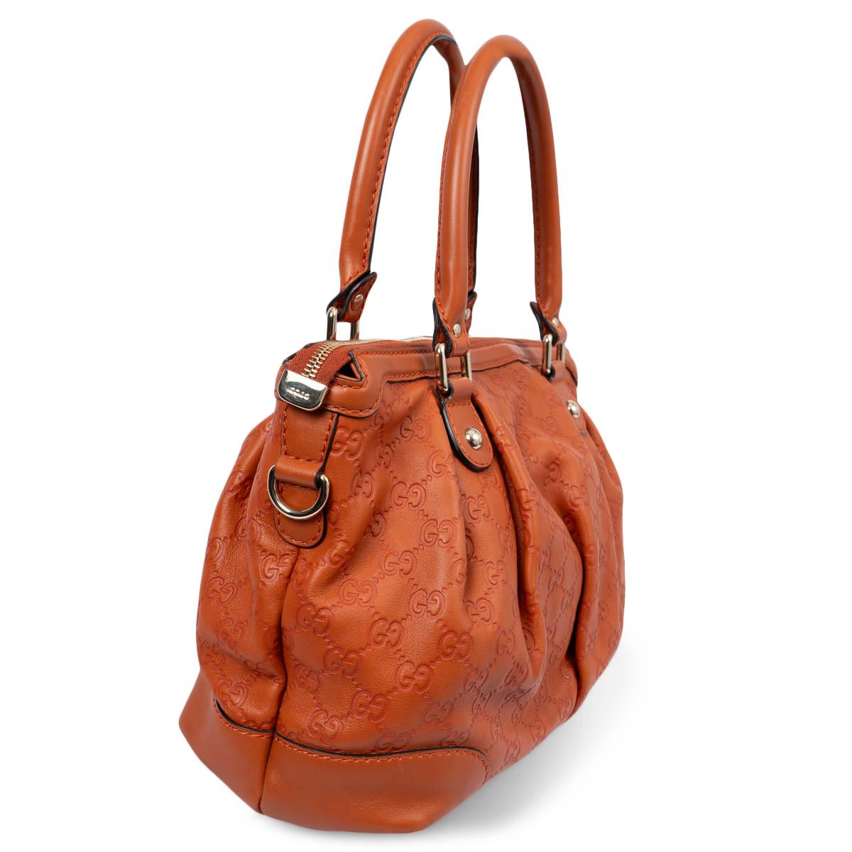 100% authentic Gucci Sukey Medium double handle bag in pumpkin orange Guccissima leather. Features gold-tone hardware, a detachable and adjustable shoulder strap and a ring with GG leather hangtag. Opens with a two-way zipper on top. Lined in beige