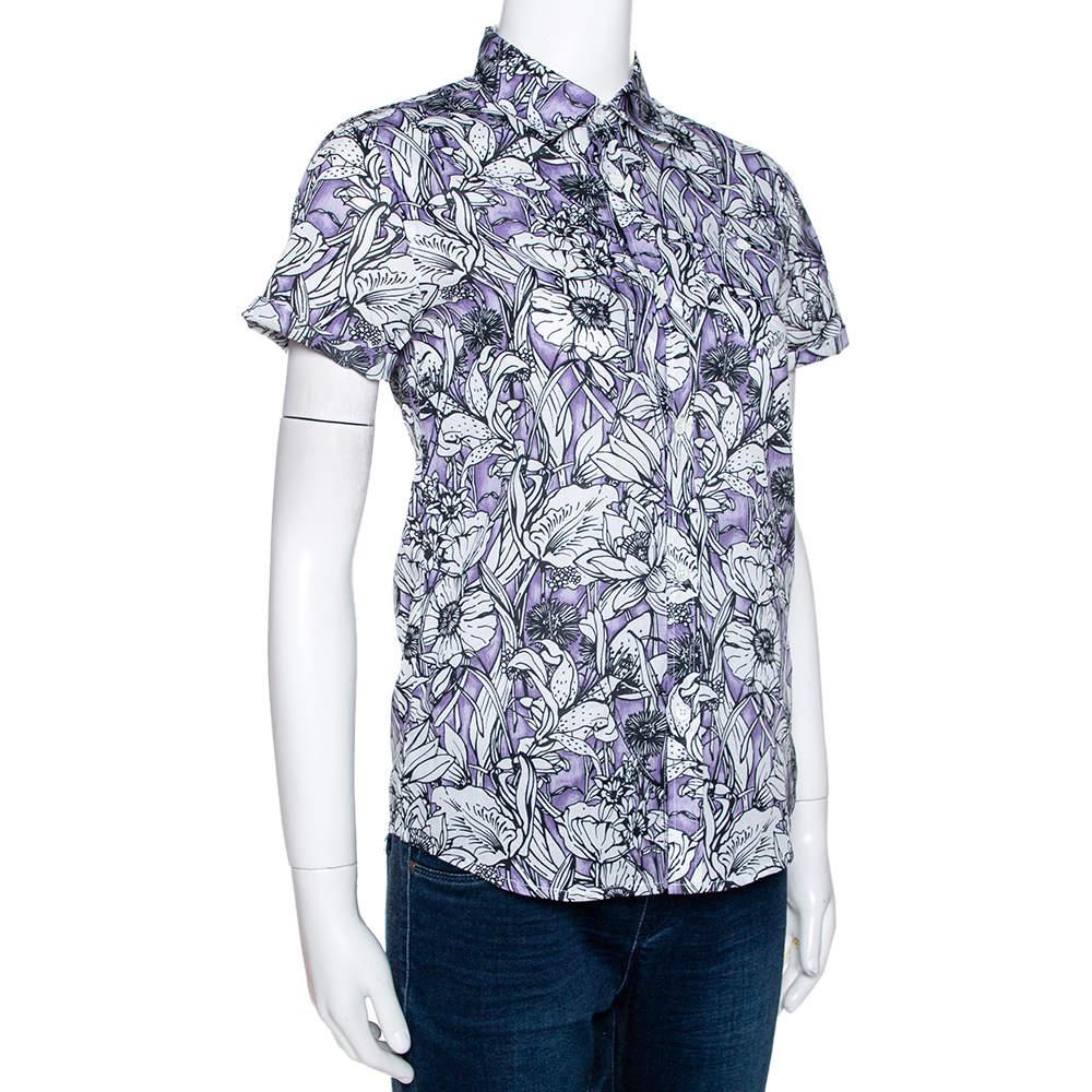 This shirt from the luxury house of Gucci is an example of classic designing. If you're looking for a simple and chic look, this is the shirt for you. It is crafted from cotton and carries a lovely purple floral print throughout. It has short