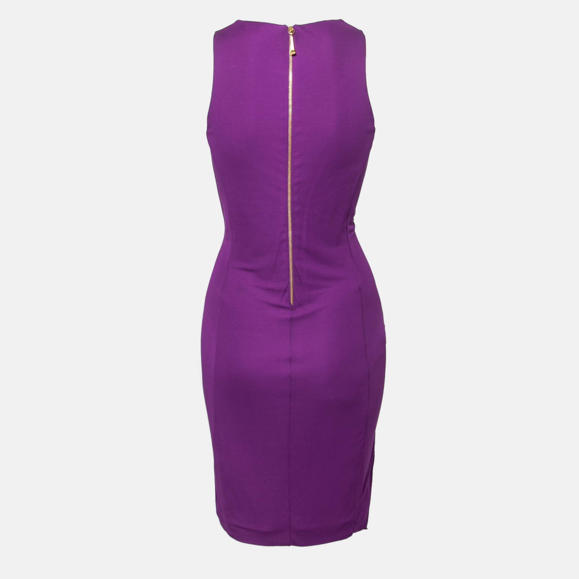 Make a glamorous entrance at the next cocktail party wearing this gorgeous dress from Gucci. The purple dress displays a fabulous tie detail on the front and has a flattering silhouette. A deep V-neckline completes this sleeveless dress that you can