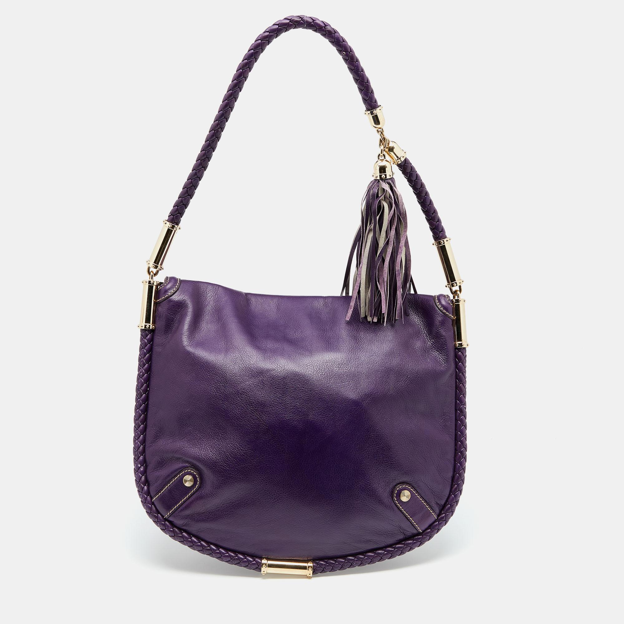 Simple details, high quality, and everyday convenience mark this Britt shoulder bag by Gucci. The bag is made of purple leather and it features a single handle, a gold-tone GG logo on the front, and a spacious interior.

Includes: Original Dustbag