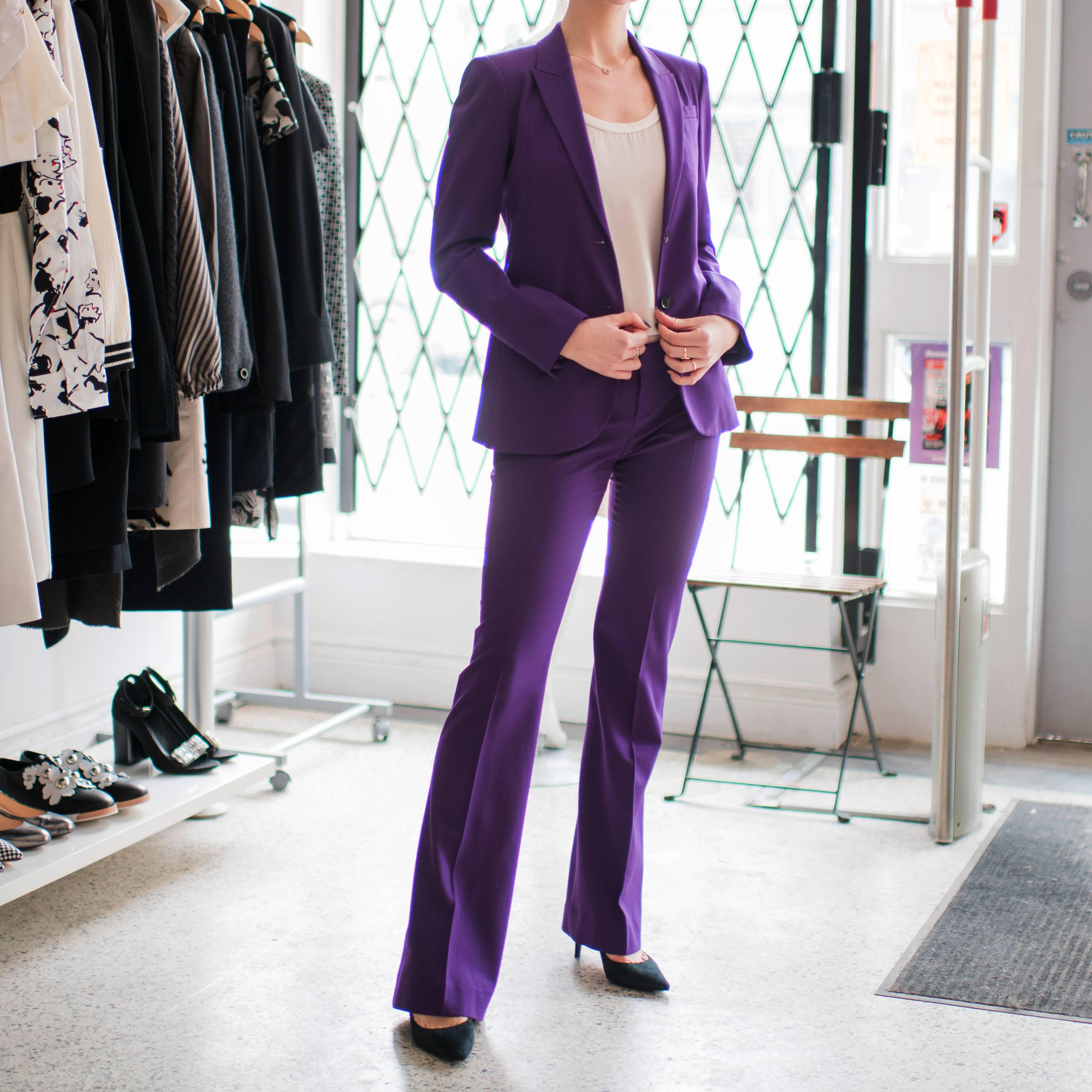 Gucci Purple Pants Suit.  Mid-rise skinny flare pant, fitted blazer, lined with vibrant signature flora and fauna pattern fabric. Marked size IT 40 (USA 4).  Model is 5’6” tall.  To fit 33” bust, shoulder seam 14.5”, sleeve 23.5”,  back neck seam to