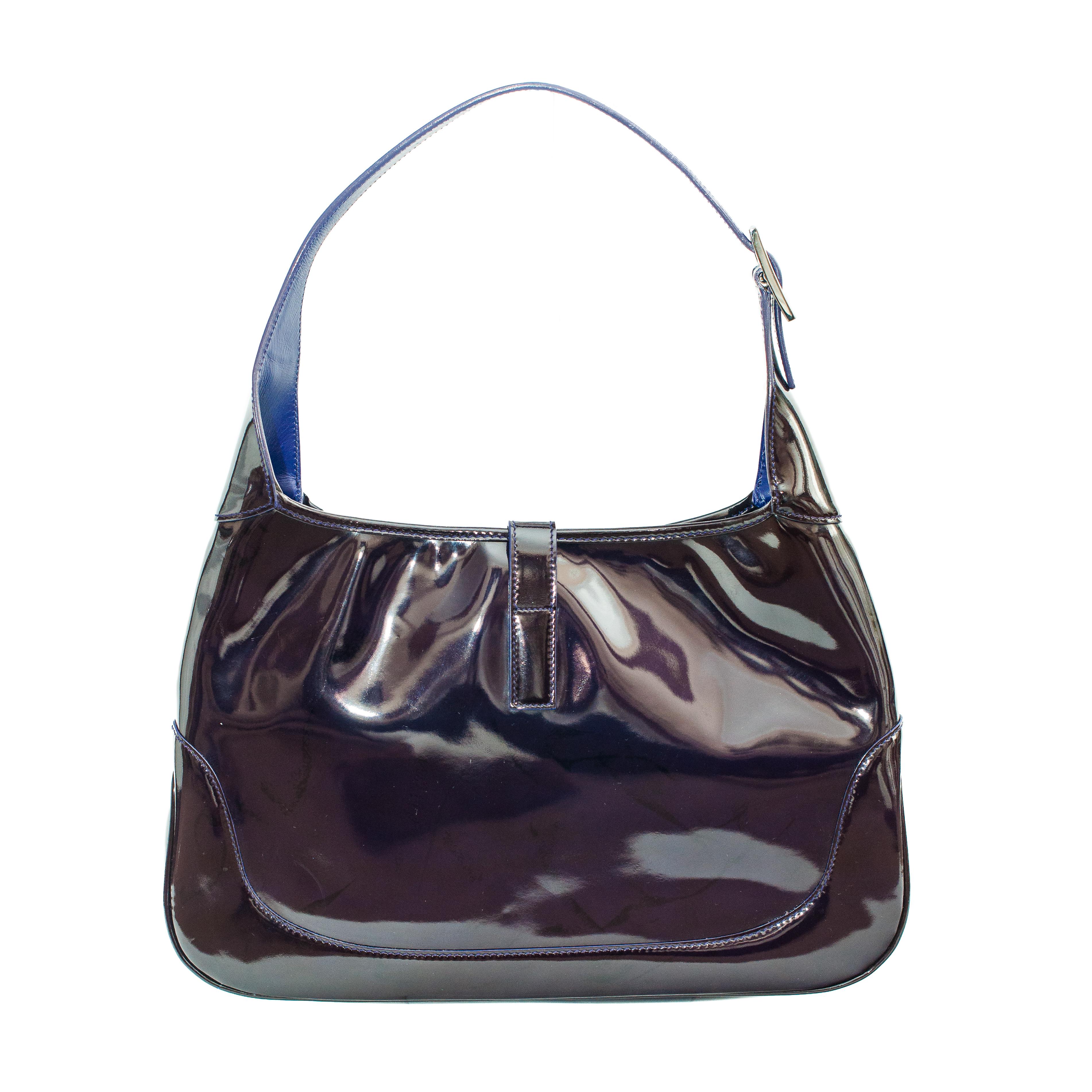 The patent leather Jackie is quite an uncommon find and judging by its appearance,  we're not sure why they didn't produce more.

The patent leather is coloured a deep and rich shade of purple, in the dark it appears almost black and in the sunlight