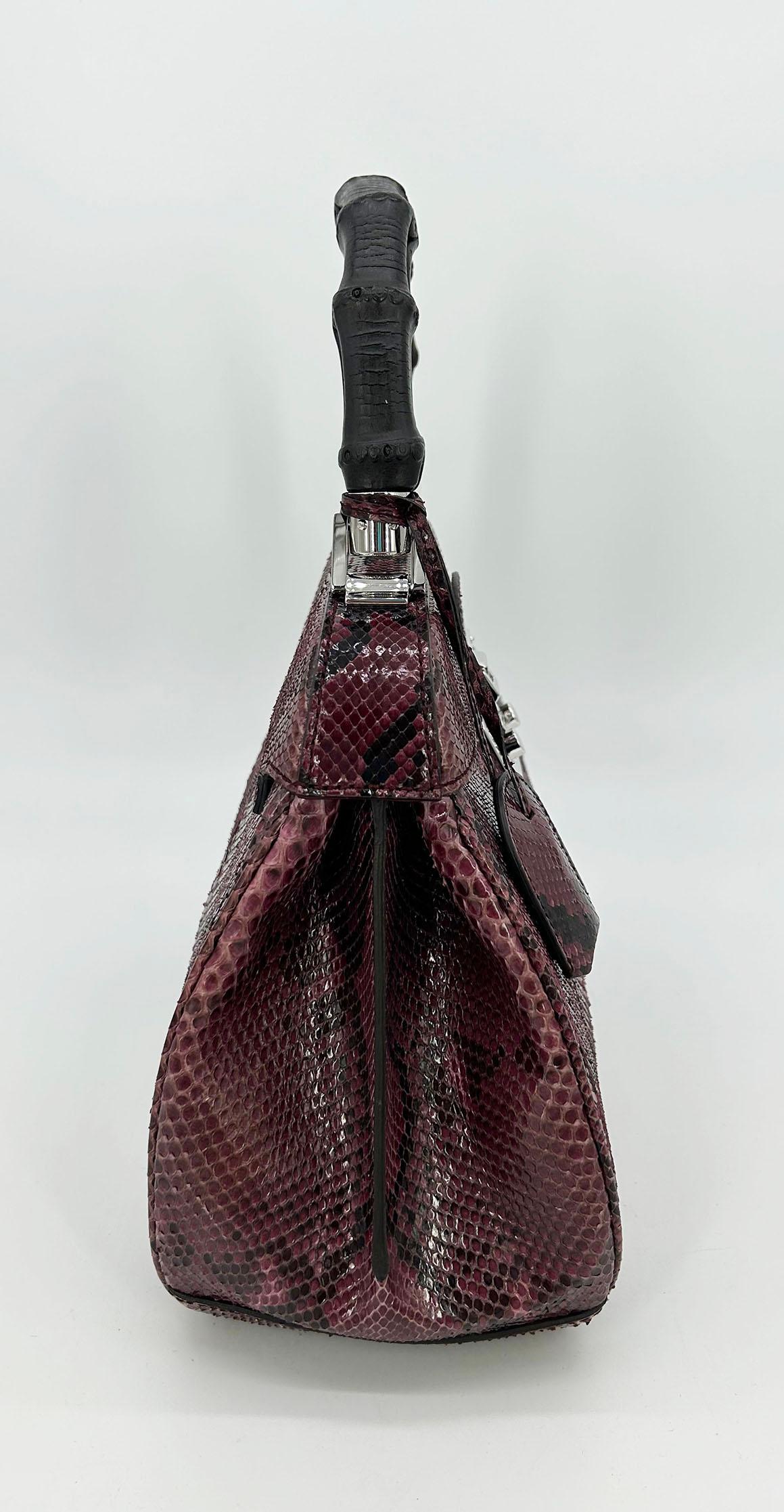 Gucci Purple Python Lady Lock Bag in excellent condition. Purple python snake skin exterior trimmed with a painted black bamboo top handle and silver hardware. Front pinch lock closure opens to a purple suede and leather lined interior with two