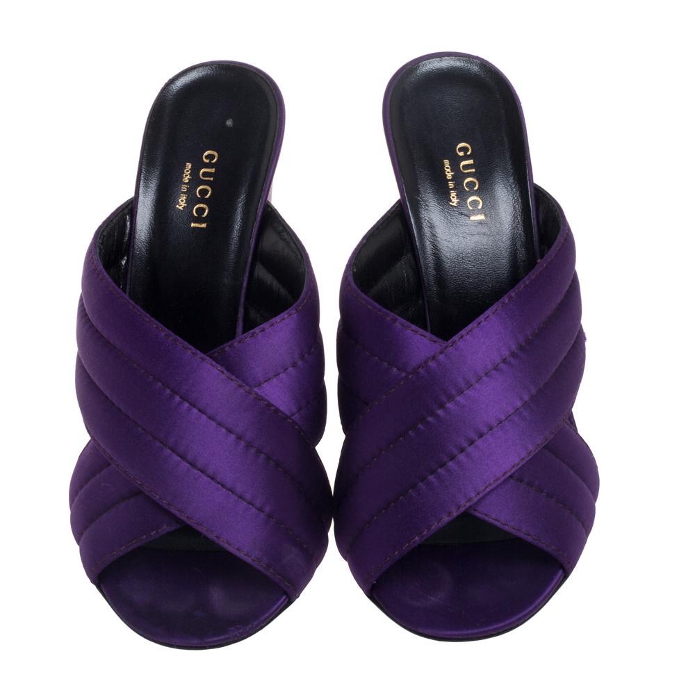 These fashionable sandals from Gucci will give your entire ensemble a makeover. Crafted with quilted satin, this pair features open toes, 10.5 cm block heels, and durable leather soles. These fine purple mules will offer both elegance and comfort.

