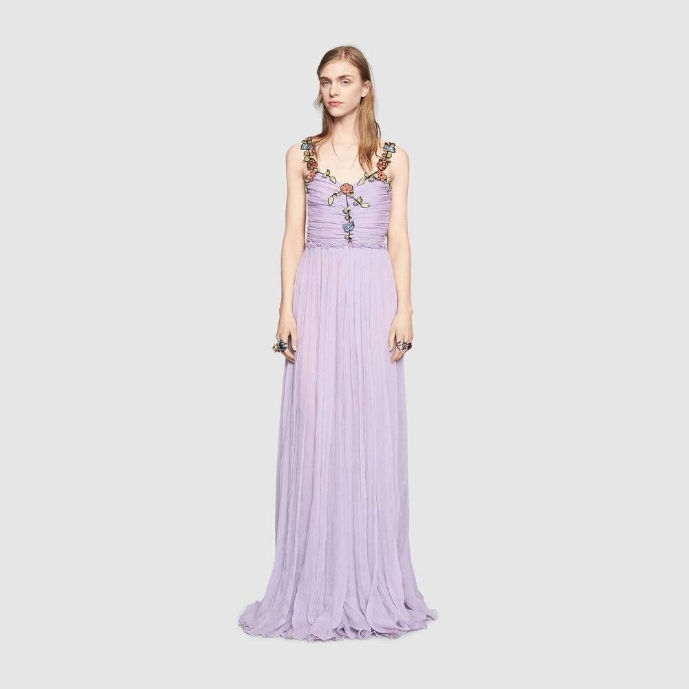 A beautiful flowing chiffon gown with a multilayer skirt that gathers at the waist.
The top is decorated with vine and flower appliqués that adds an ethereal dimension to the gown.
Pale lavender chiffon crepe.
Top with central stitching detail to