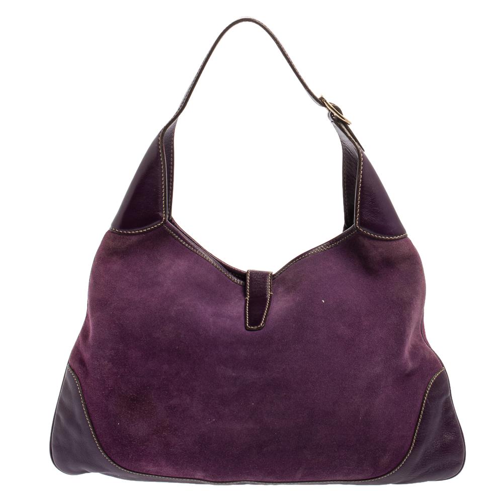 Gucci has always offered a bevy of cult-favorite bags, just like this Jackie O’ Bouvier hobo created as a homage to Jacqueline Kennedy Onassis. It is crafted from suede and leather in a purple shade and flaunts embellishments on the front. A piston