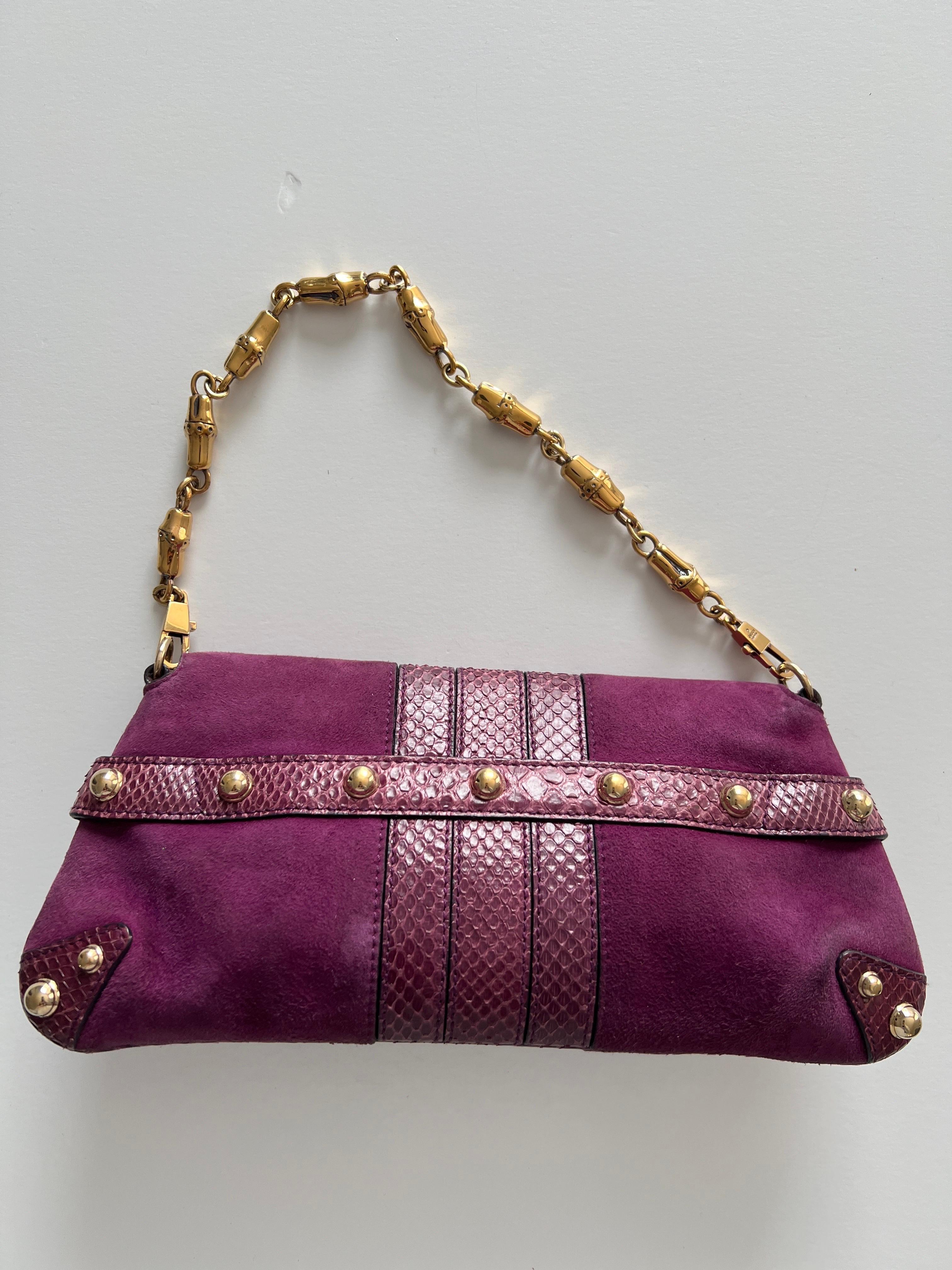 This adorable Gucci Purple Suede and Snakeskin Horsebit Chain Bag features gorgeous purple suede with snakeskin trim. The bag has purple enamel and a gold-tone chain strap. It makes a perfect evening bag and can hold all your girly essentials, such