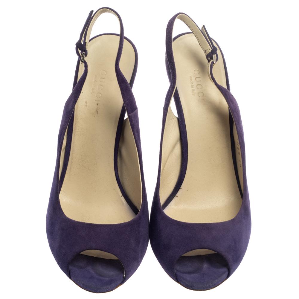 Narrow vamps forming the slingback and a slender ankle strap take the glamourous look of these high heels a notch higher. These Gucci peep-toe heels with an island platform are made of gorgeous purple suede. The leather insole and the silver-tone