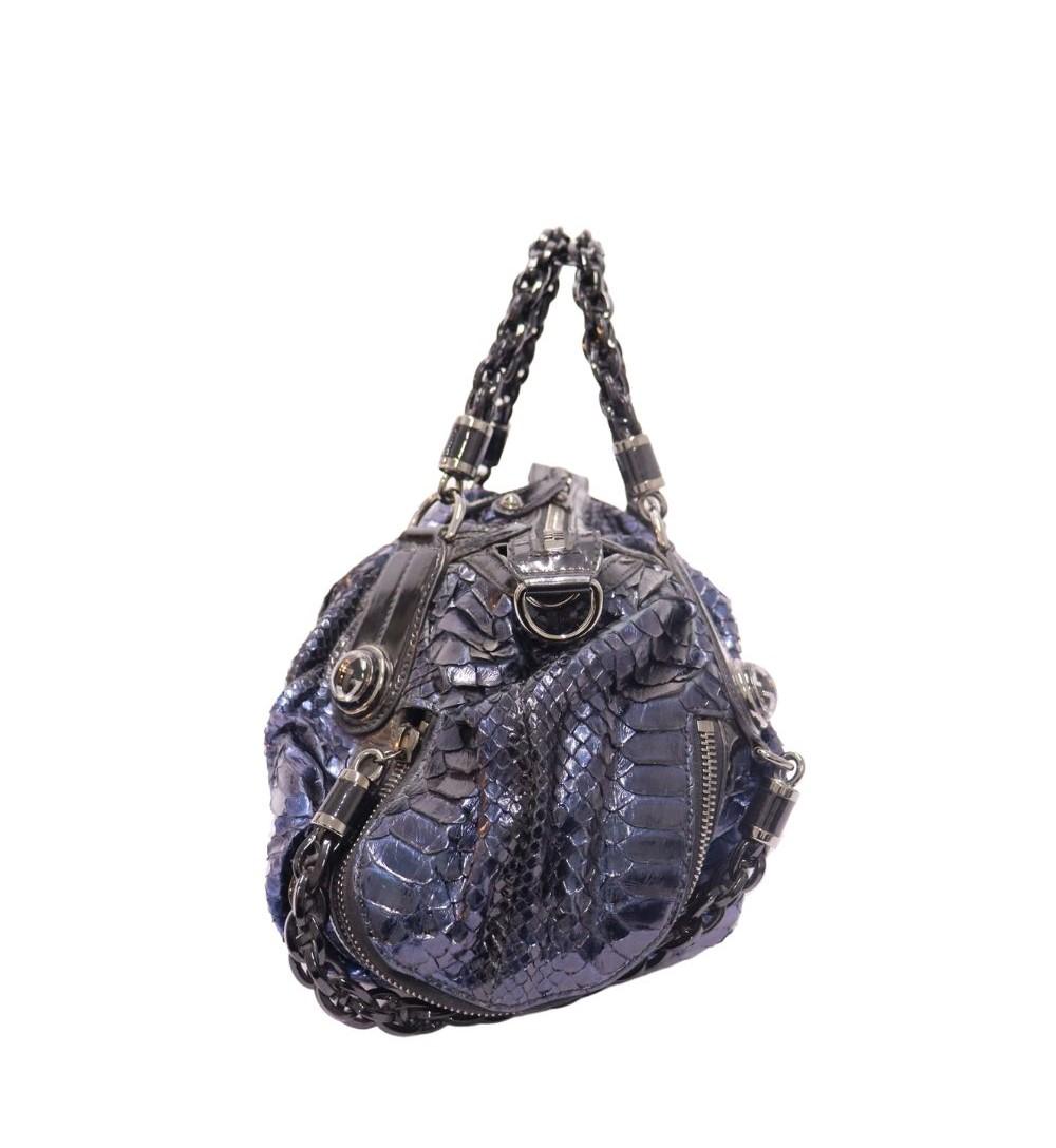 Gucci Python Galaxy Satchel, Features python print leather, shoulder strap, two top handles and one interior zipper pocket.

Material: Leather
Hardware: Silver
Height: 24cm
Width: 53cm
Depth: 13cm
Handle Drop: 9cm
Overall condition: Good
Interior