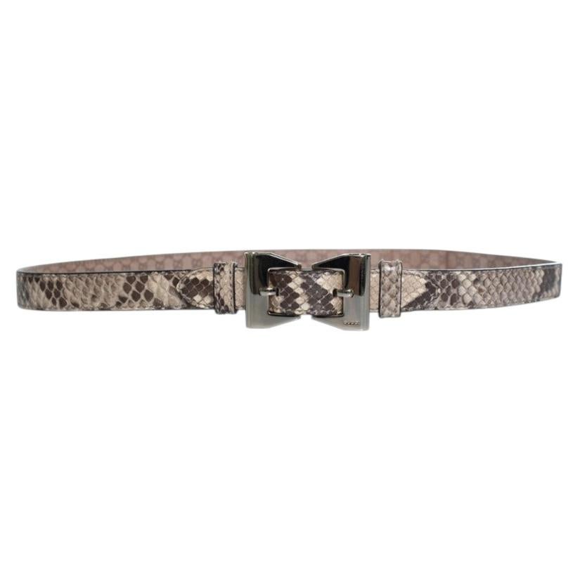 Gucci, python leather belt with gold metal bow For Sale