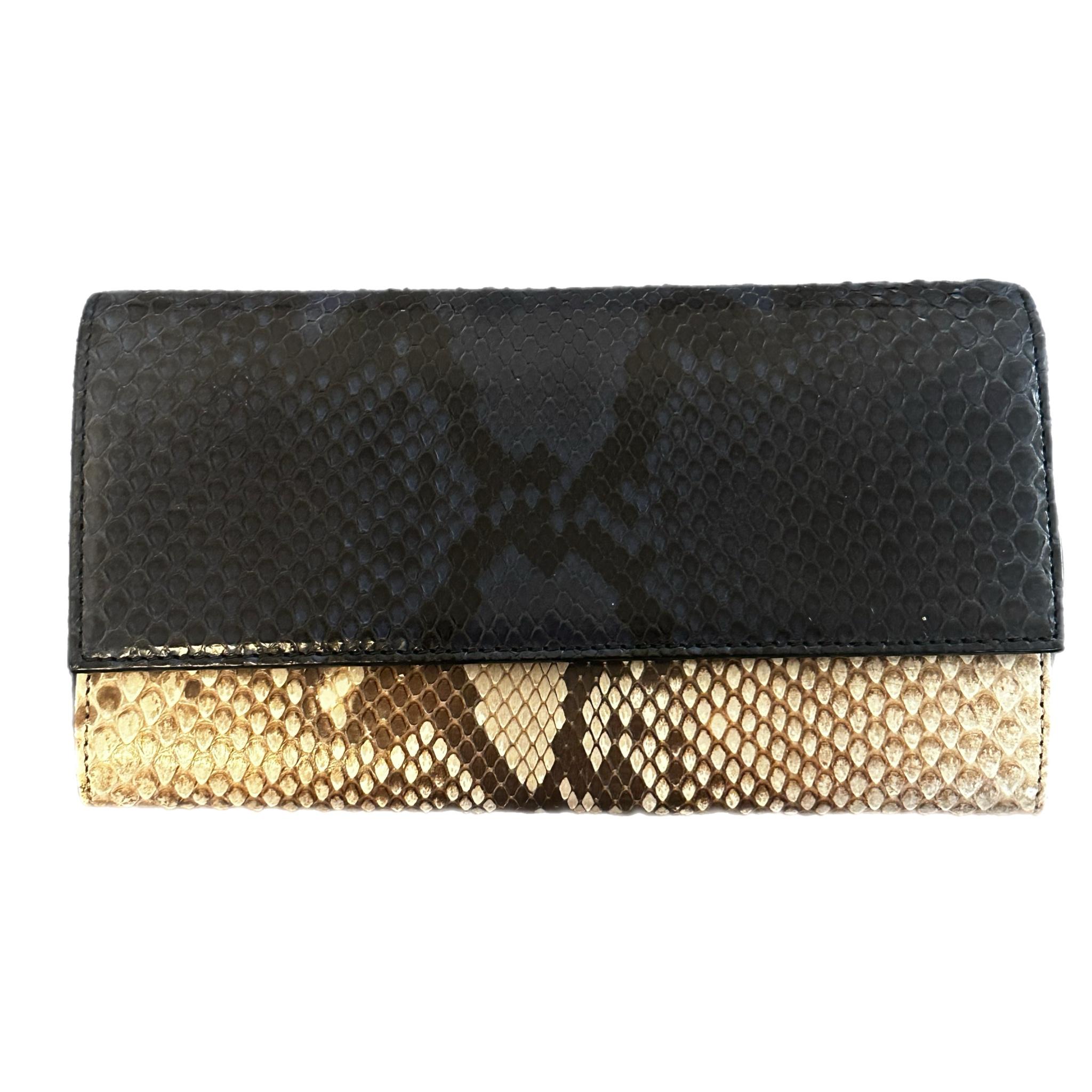 The Gucci Python Leather Clutch Long Wallet in Black x Gold Brown is a striking and luxurious accessory crafted from genuine python leather. The rich black and gold-brown tones create a bold yet elegant look, while the textured python finish adds a