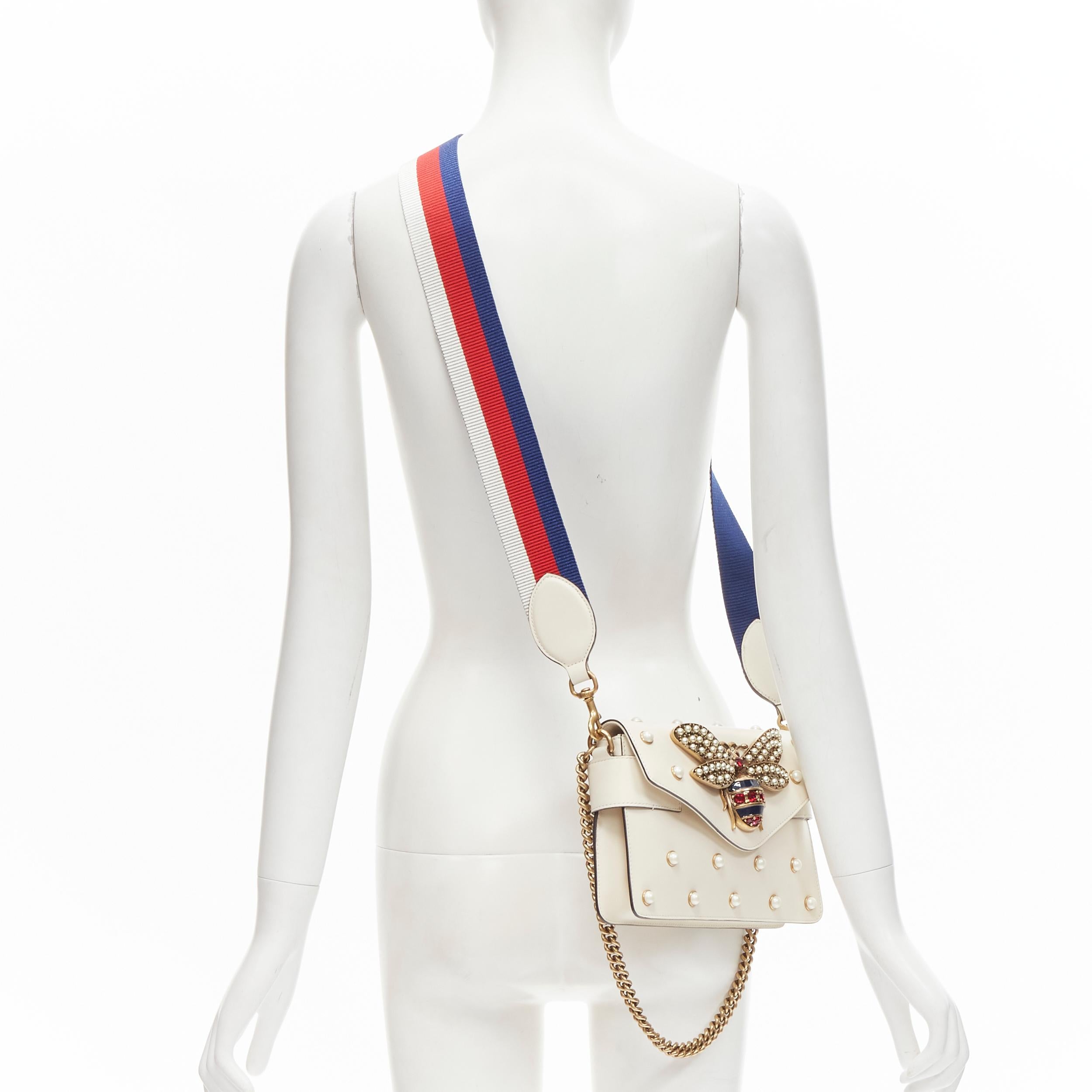 GUCCI Queen Margaret Embellished Bee pearl stud white flap crossbody bag 
Reference: ANWU/A00064 
Brand: Gucci 
Designer: Alessandro Michel 
Model: 453778 
Material: Leather 
Color: Cream 
Pattern: Solid 
Closure: Magnet 
Extra Detail: Pearl and