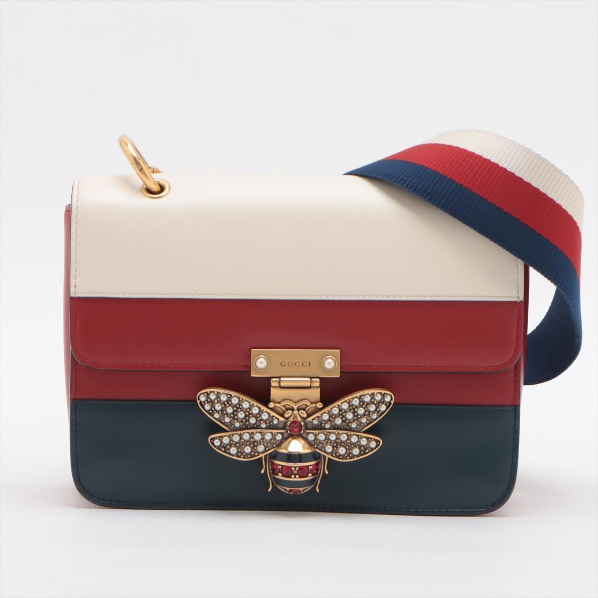 The Gucci Queen Margaret Leather Shoulder Bag in Tricolor (White, Red, and Blue) is a sophisticated and eye-catching accessory that combines bold colors with elegant design. Crafted from high-quality leather, the bag features a striking tricolor