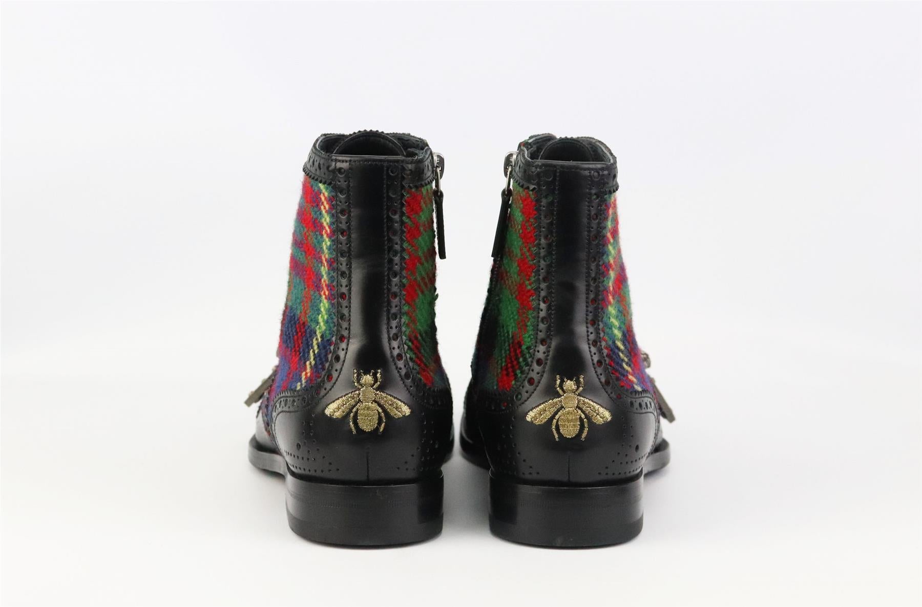 These combat-style 'Queercore' ankle boots by Gucci are made in Italy from smooth leather and tartan, they're detailed with traditional brogue-inspired pinking and perforations, and topped with the label's signature 'Dionysus' buckles. Sole measures