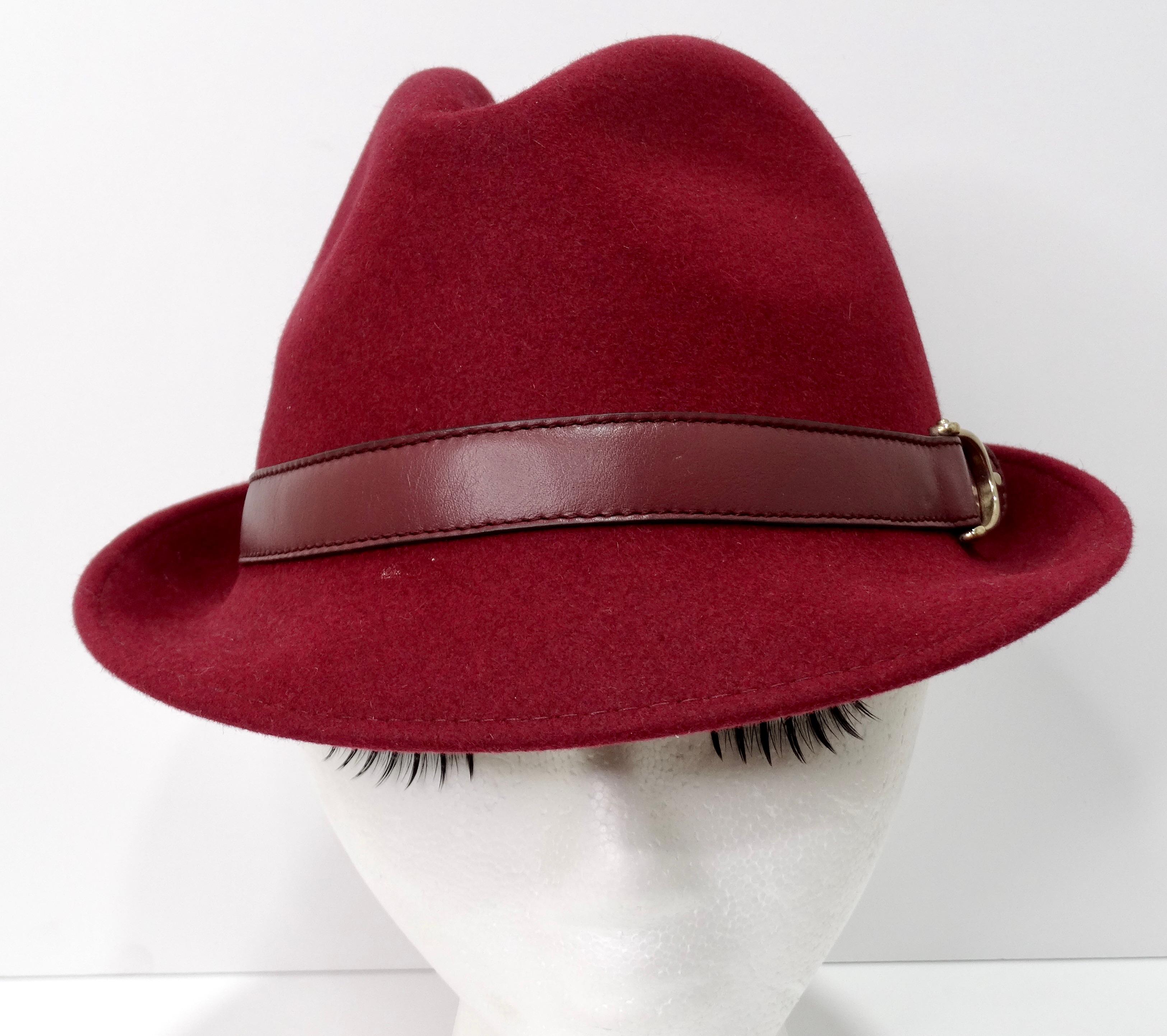 An early 2000's gem you can't pass up! A Gucci fedora is a no-brainer to add to your wardrobe. This is a beautiful burgundy rabbit fur fedora-style hat featuring a burgundy leather strap with a gold buckle adorning the side. It would look great with