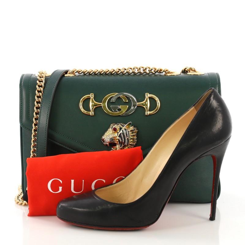 This Gucci Rajah Chain Shoulder Bag Leather Medium, crafted in green leather, features chain-link shoulder strap, enameled tiger head with crystals—inspired by a vintage Hattie Carnegie jewelry design, Horsebit and the Interlocking G detailing and