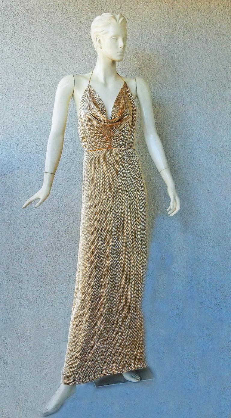 A rare Gucci vintage 2006 runway gown as seen on Zoe Saldana and Keira Knightly.    Its style is shimmery opulence and sophistication. A wow gown!

Halter bodice offers a sexy low draped neckline; fitted at waist and flairs out a bit.  All hand