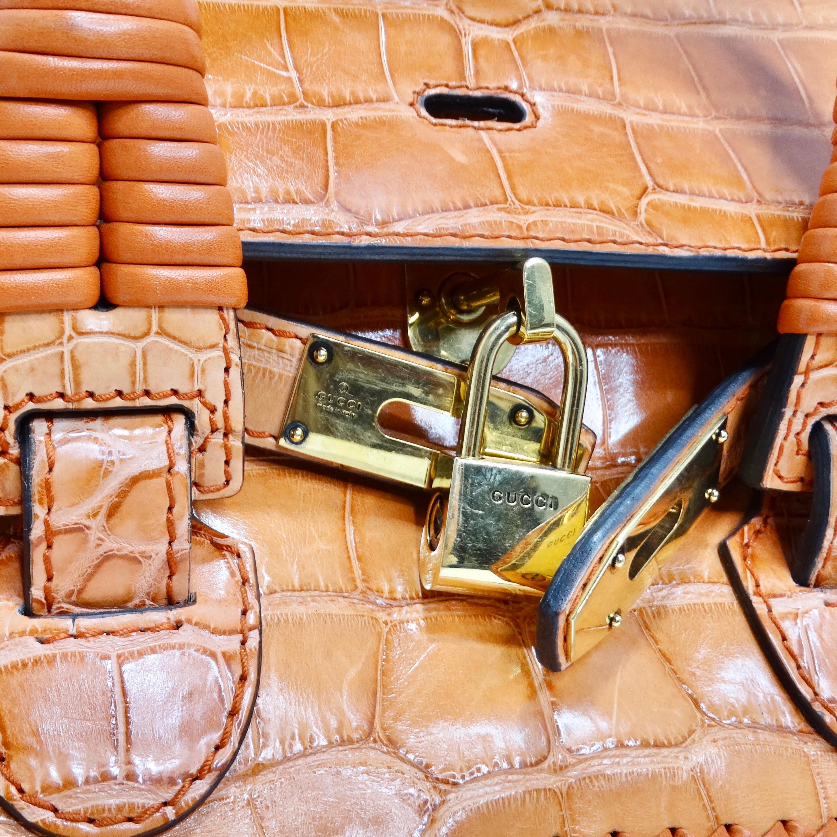 Introducing the Gucci Rare Orange Crocodile Leather Woven Top Handle Bag, a stunning and exclusive piece that exudes luxury and sophistication. Crafted from rich orange crocodile leather, this stylish tote features exquisite artisanal woven
