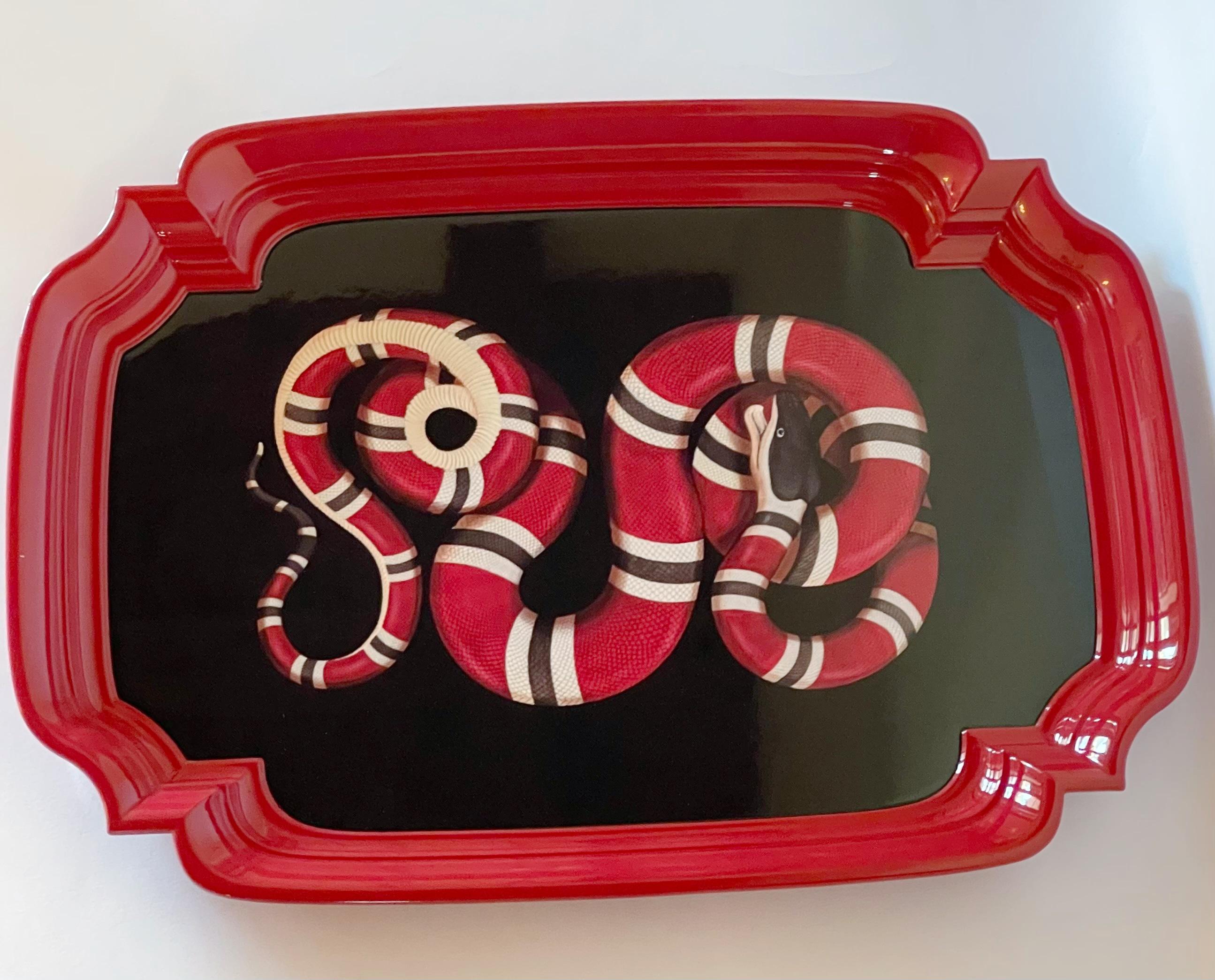 Gucci black metal tray with a print of a snake and raised duel rimmed red borders, designed to serve as a display or serving dish / Made in Italy
Original stamp at underside / comes in original box
Width: 20 inches / Depth: 15 inches / Height: 1.5