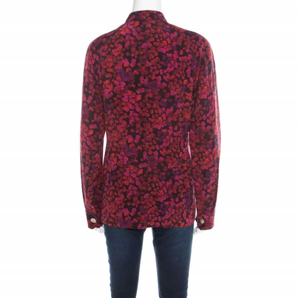 Let everyone around go gaga over your fashion sense when you wear this Gucci blouse to your next outing! It is made of 100% silk and features a multicolor floral print all over it. It flaunts a bow detail on the front and comes with long sleeves. It