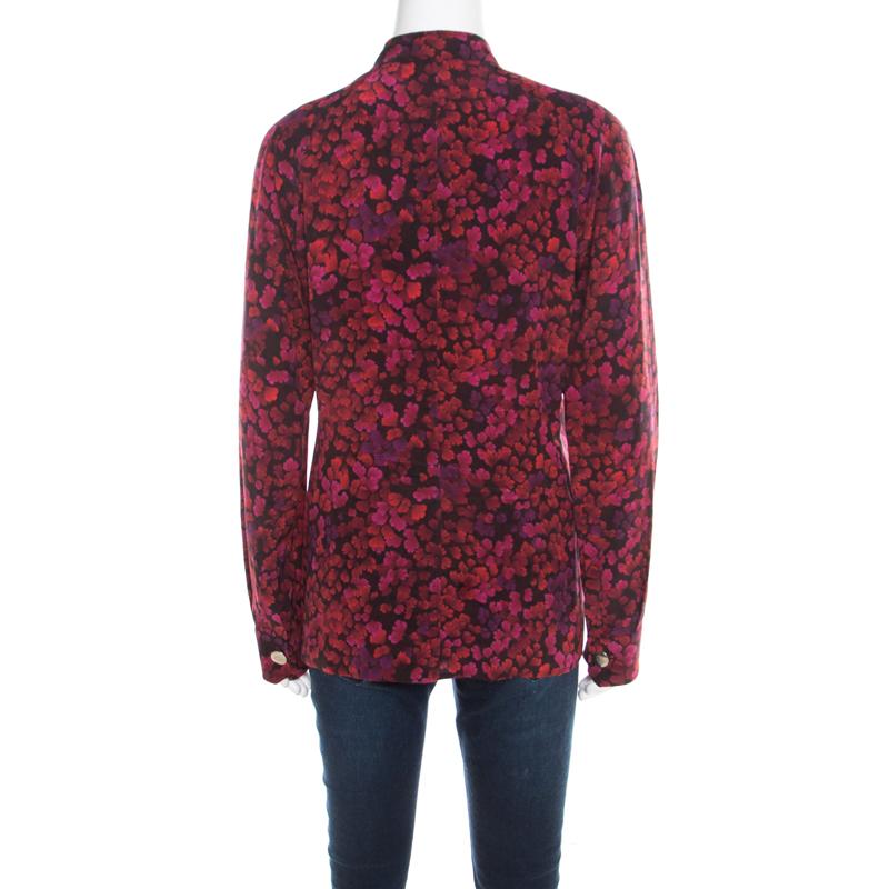 Let everyone around go gaga over your fashion sense when you wear this Gucci blouse to your next outing! It is made of 100% silk and features a multicolor floral print all over it. It flaunts a bow detail on the front and comes with long sleeves. It