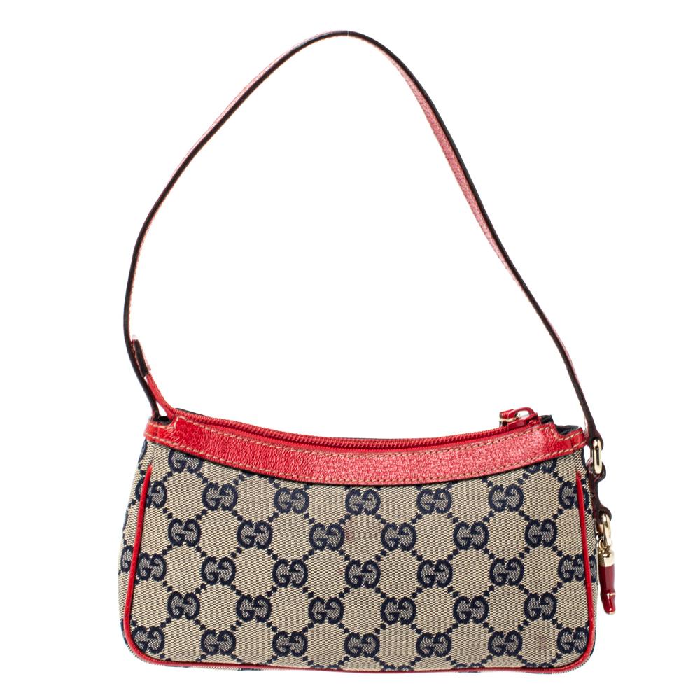 This handy Pochette bag is from the house of Gucci. It has been crafted in Italy and made from signature GG canvas and leather. It comes in beige & red hues. It is equipped with a canvas interior which will house the essentials you cannot do