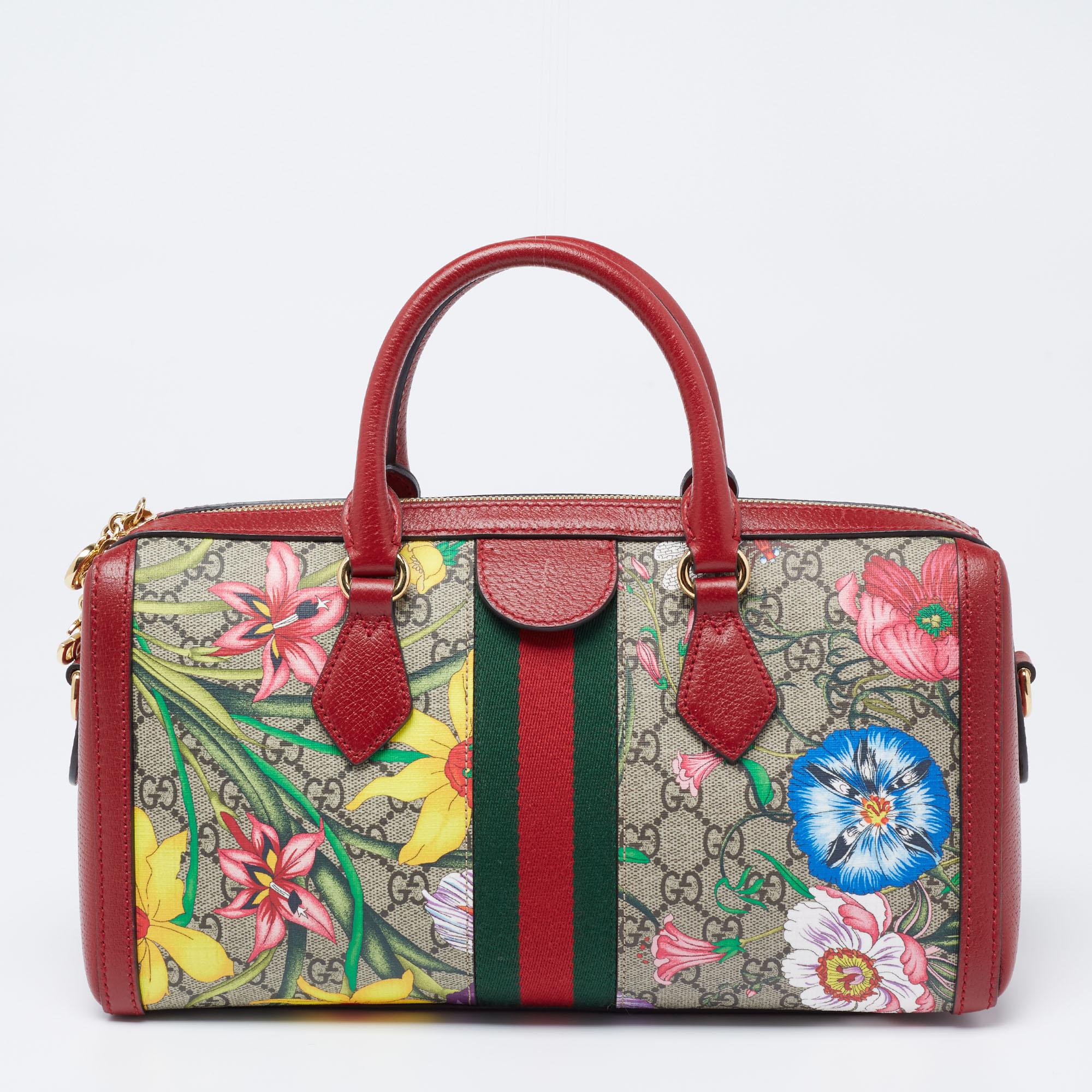 Crafted from GG Supreme canvas and leather, this Gucci Ophidia bag arrives in a structured shape for a sophisticated look. It features the iconic Web stripe, Flora motifs, and the GG motif—all Gucci codes. The bag suspends from two short handles and