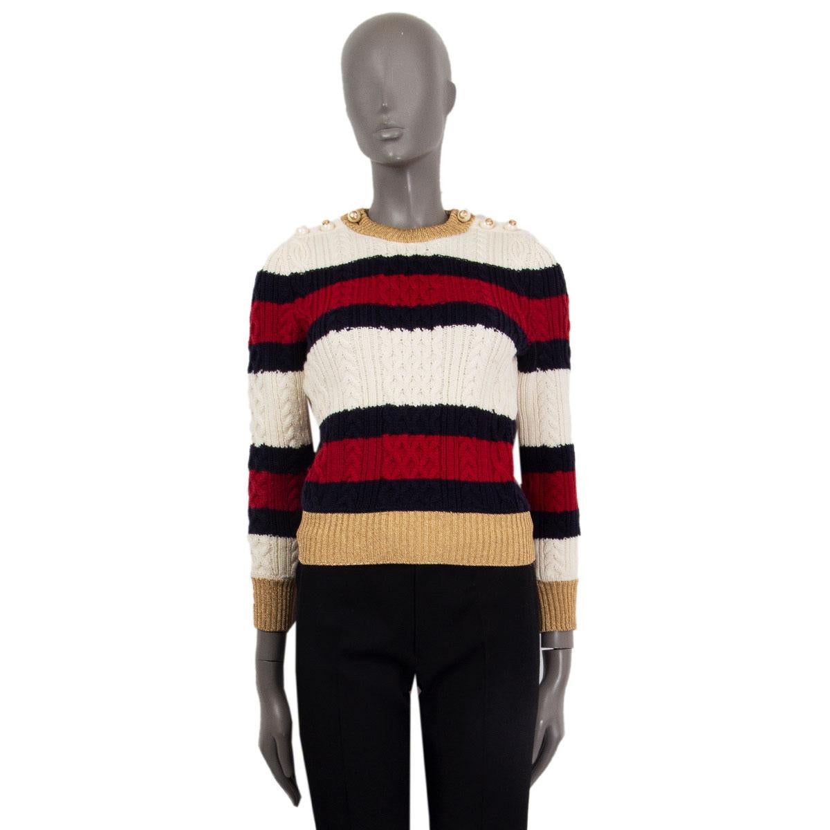 Gucci striped cable knit sweater in ivory, navy, and red wool (100%) sweater. It's spun in Italy to a slim silhouette with contrasting gold lurex ribbed-knit detailing across the neckline, cuffs, and hem. The sweater features chunky faux-pearl